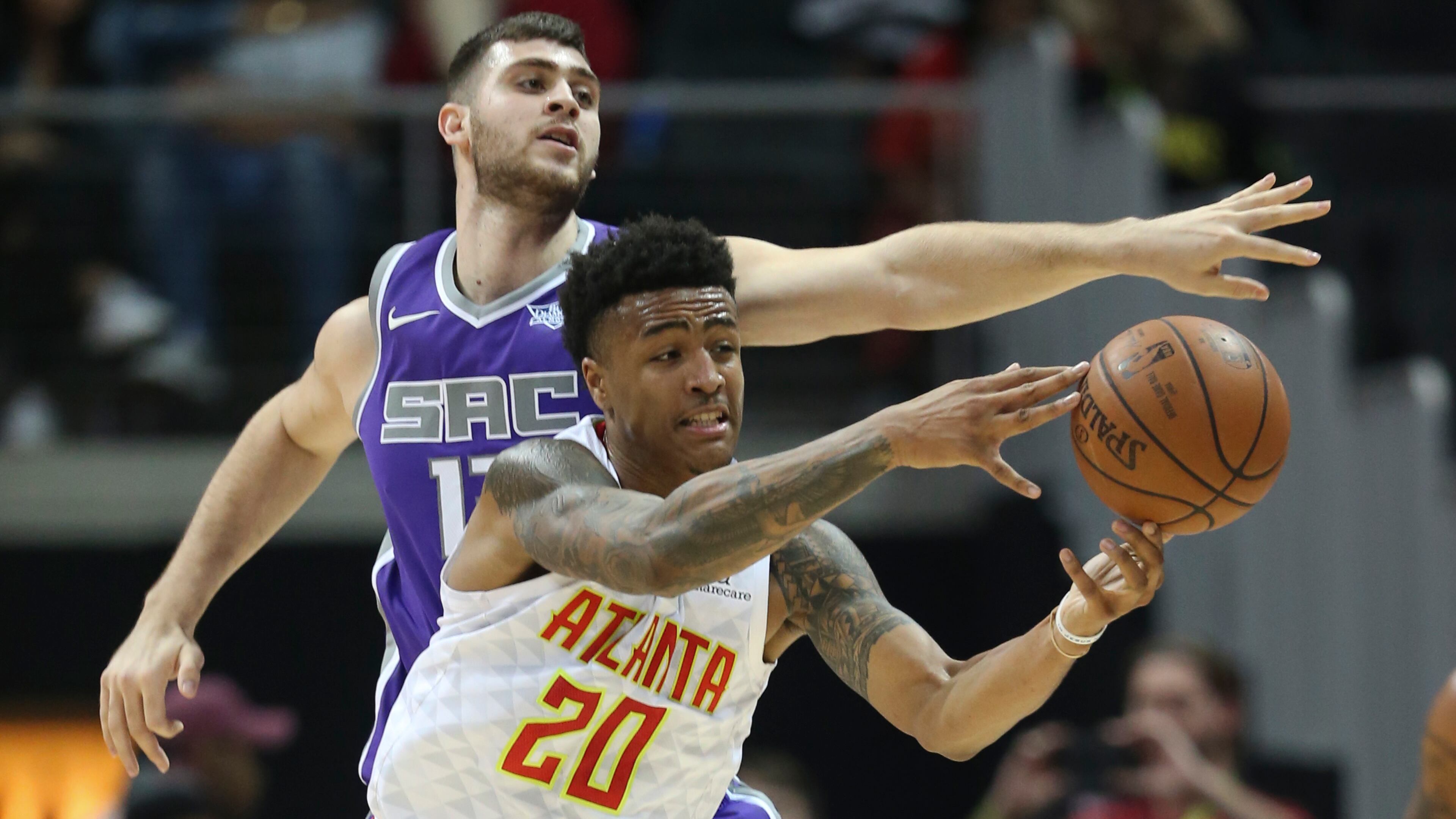 Atlanta Hawks forward John Collins (20) has the ball knocked away by Sacramento Kings center Georgios Papagiannis (13) during the second half of an NBA basketball game Wednesday, Nov. 15, 2017, in Atlanta. (AP Photo/John Bazemore)