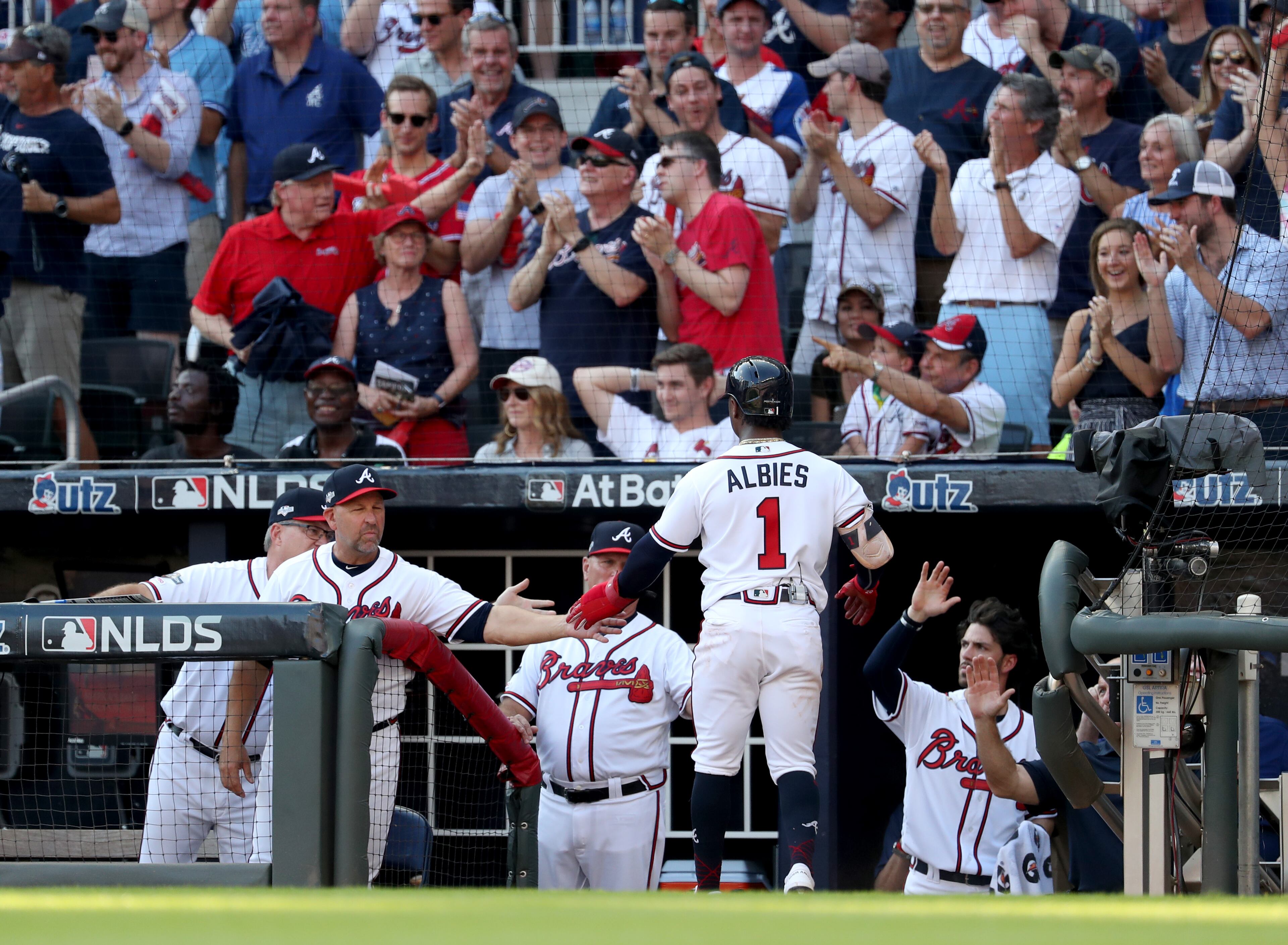 Braves second baseman Ozzie Albies (1) scores a run in the first inning against the St. Louis Cardinals in Game 1 at SunTrust Park Thursday. (JASON GETZ/SPECIAL TO THE AJC)