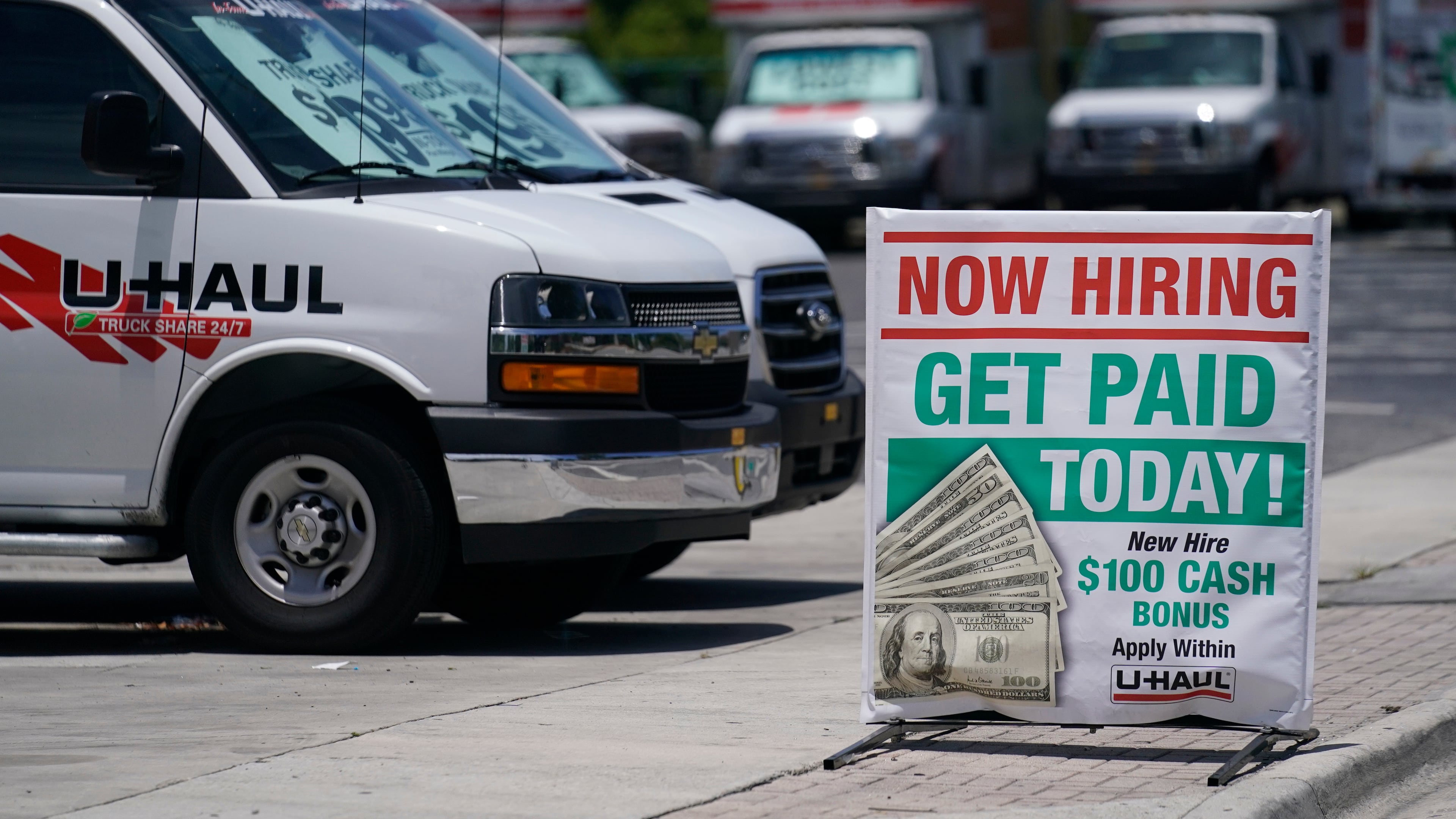 FILE - A sign at a UHaul store looking to hire employees is also offering a bonus, Thursday, May 20, 2021, in Boynton Beach, Fla. (AP Photo/Marta Lavandier, File)