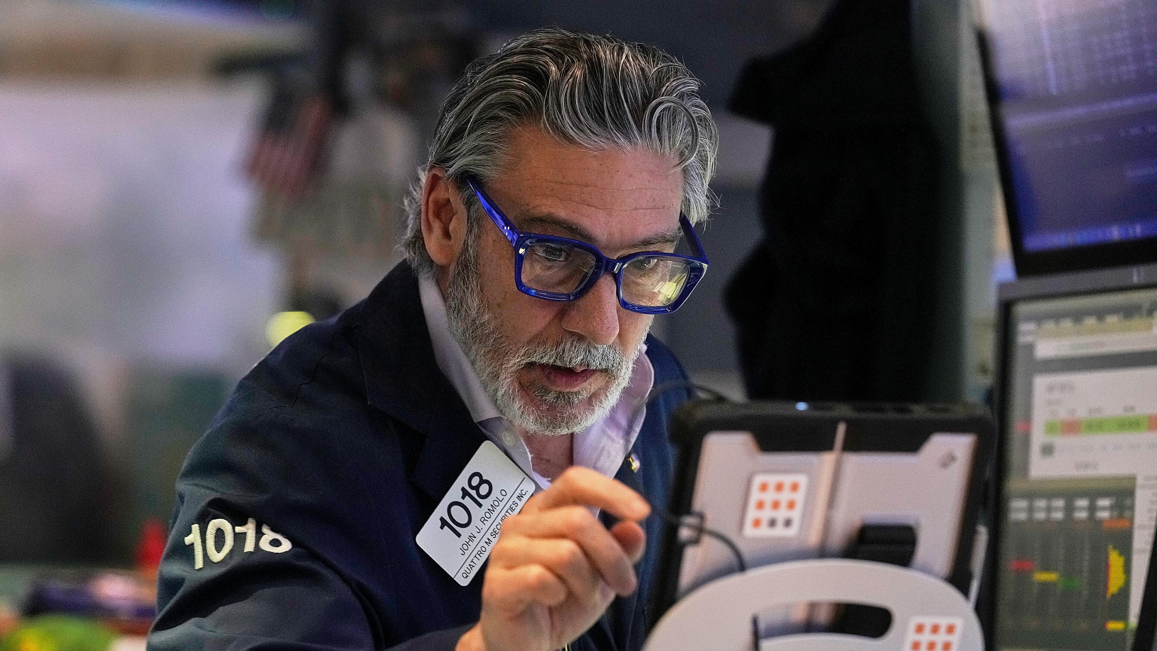 Trader John Romolo works on the floor of the New York Stock Exchange, Monday, Jan. 12, 2026. (AP Photo/Richard Drew)