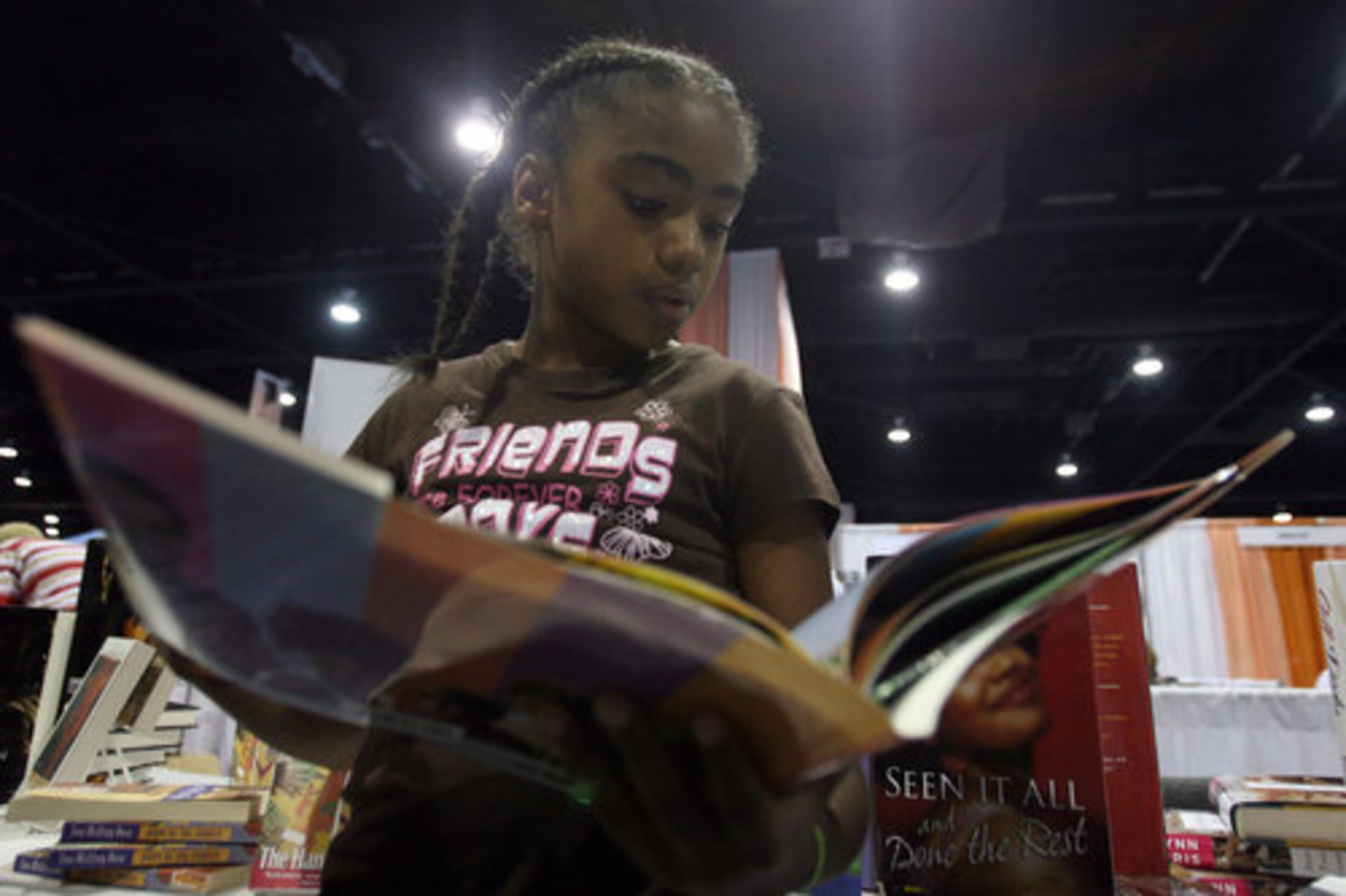 Taylor McBride, 9, reads a book in the Literary Cafe.