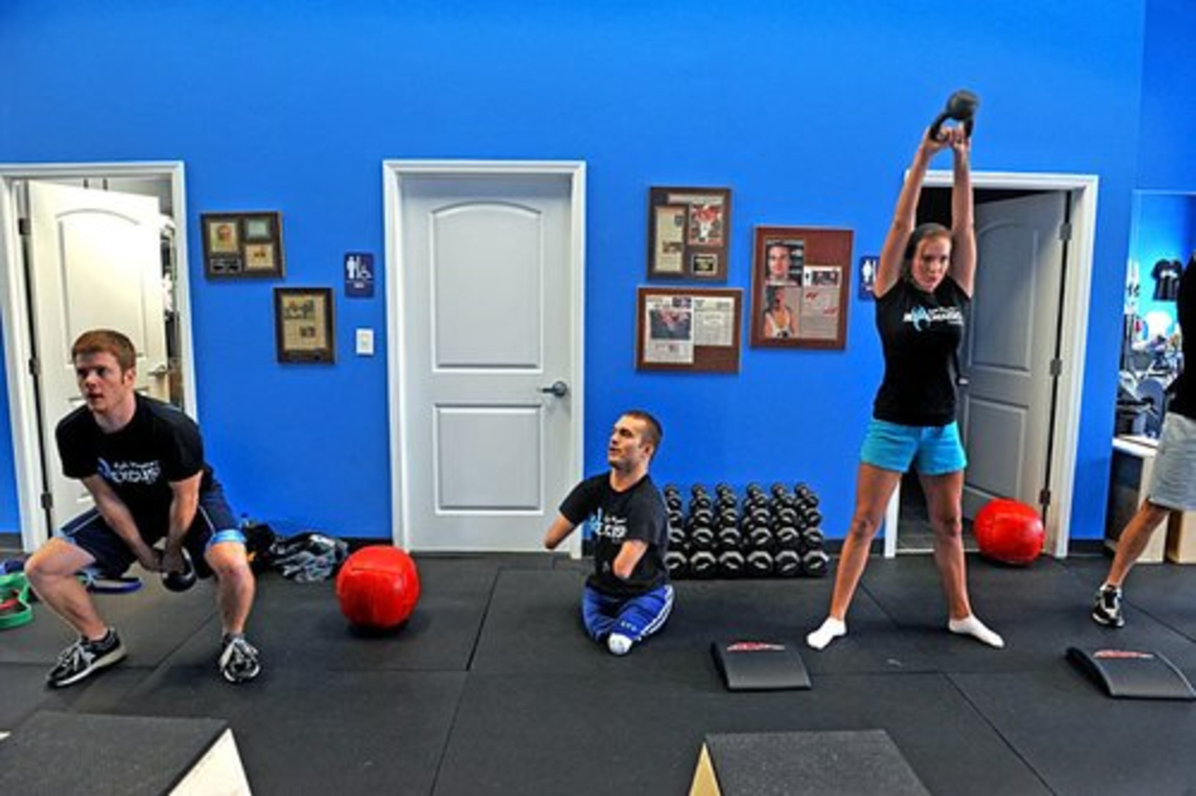 Maynard helps instruct Alex Shofner, left and his sister Amber Maynard, right.