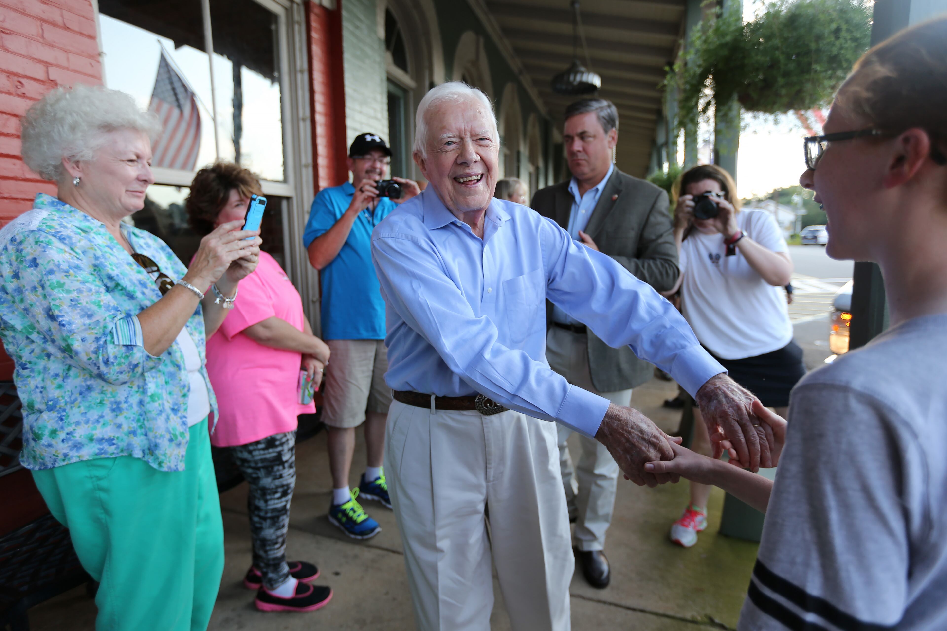 President Jimmy Carter shakes hands as he arrives at a birthday party for his wife Rosalynn on Saturday evening August 22, 2015 in Plains. Ben Gray / bgray@ajc.com