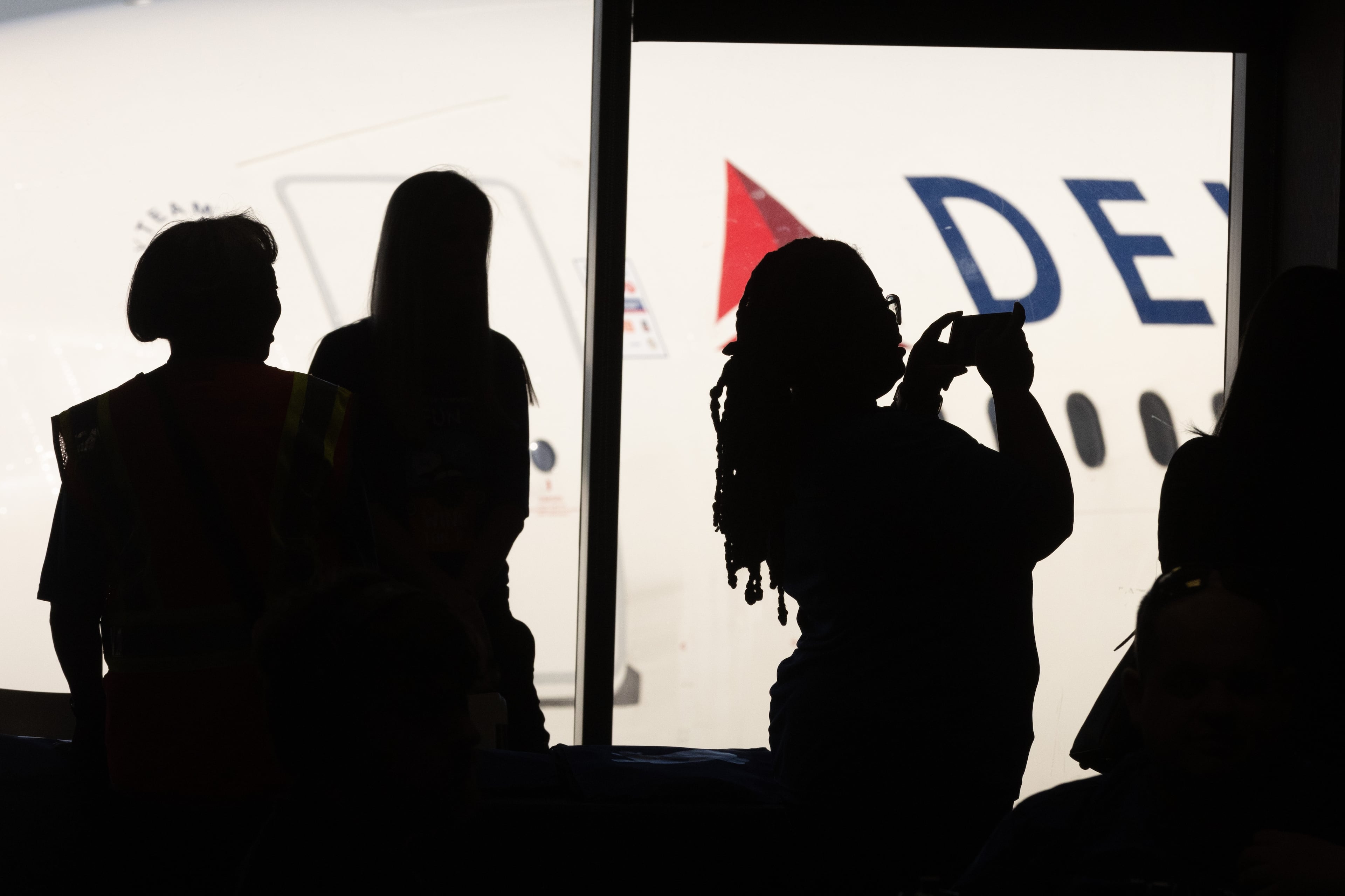 Participants take photographs and look at the airplanes during A Wings For All event at the Hartsfield-Jackson Atlanta International Airport Tuesday, April 11, 2023. (Steve Schaefer/steve.schaefer@ajc.com)