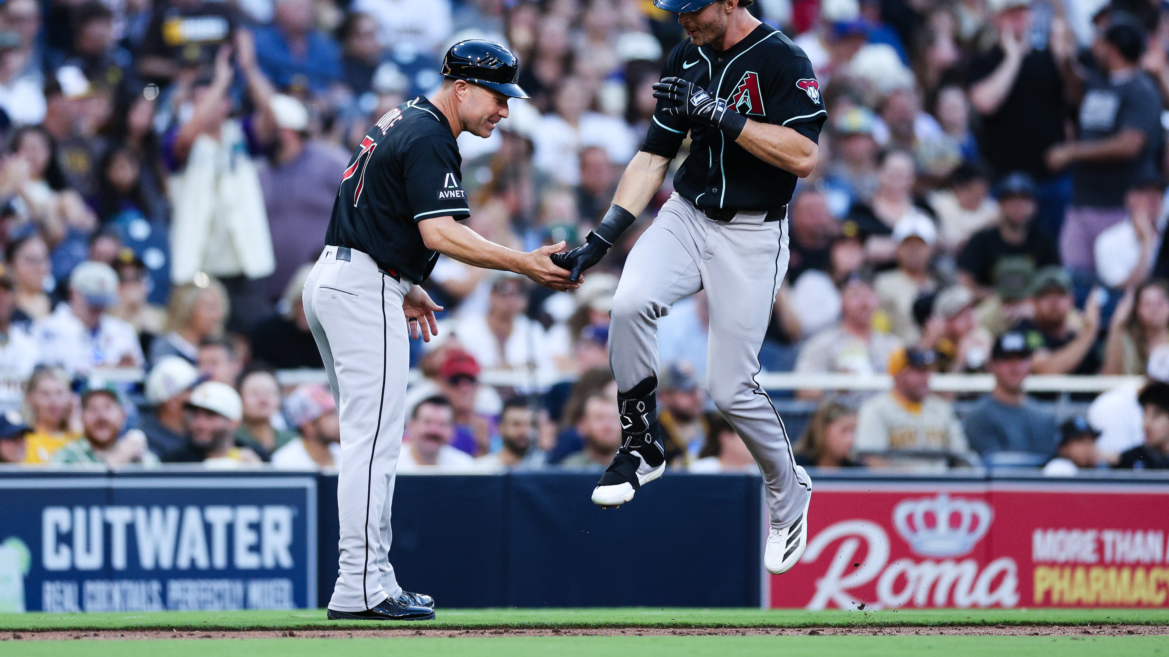 Arizona Diamondbacks' Max Kepler, right, is congratulated by third base coach J.R. House, left, after hitting a three-run home run against the San Diego Padres in the third inning of a baseball game Monday, July 6, 2026, in San Diego. (AP Photo/Derrick Tuskan)