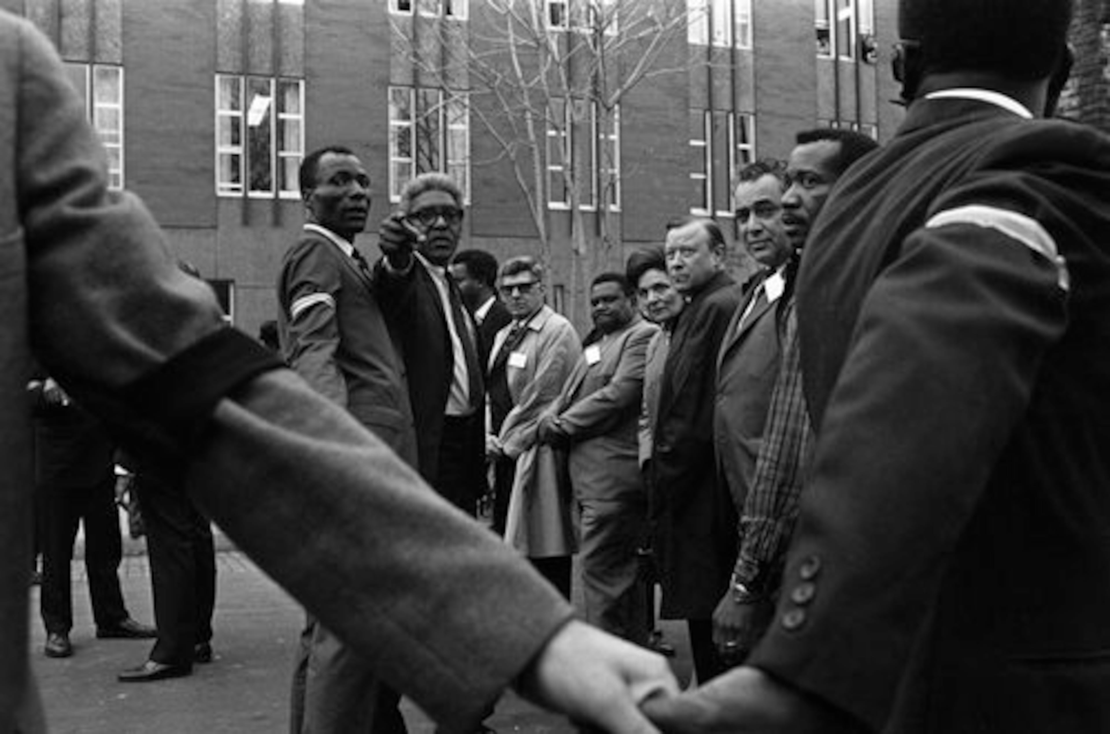 Civl rights leader Bayard Rustin points while talking with William Lucy, left, a representative of municipal employees, as they organize a march in Memphis, Tenn., April 8, 1968, in honor of Dr. Martin Luther King, Jr., who was assassinated in Memphis last Thursday. Others, left to right: Jerry Wurf, glasses, international president of the Municipal Workers Union; T.O. Jones; May Reuther, wife of UAW union president Walter Reuther; Reuther. Others are unidentified. (AP Photo