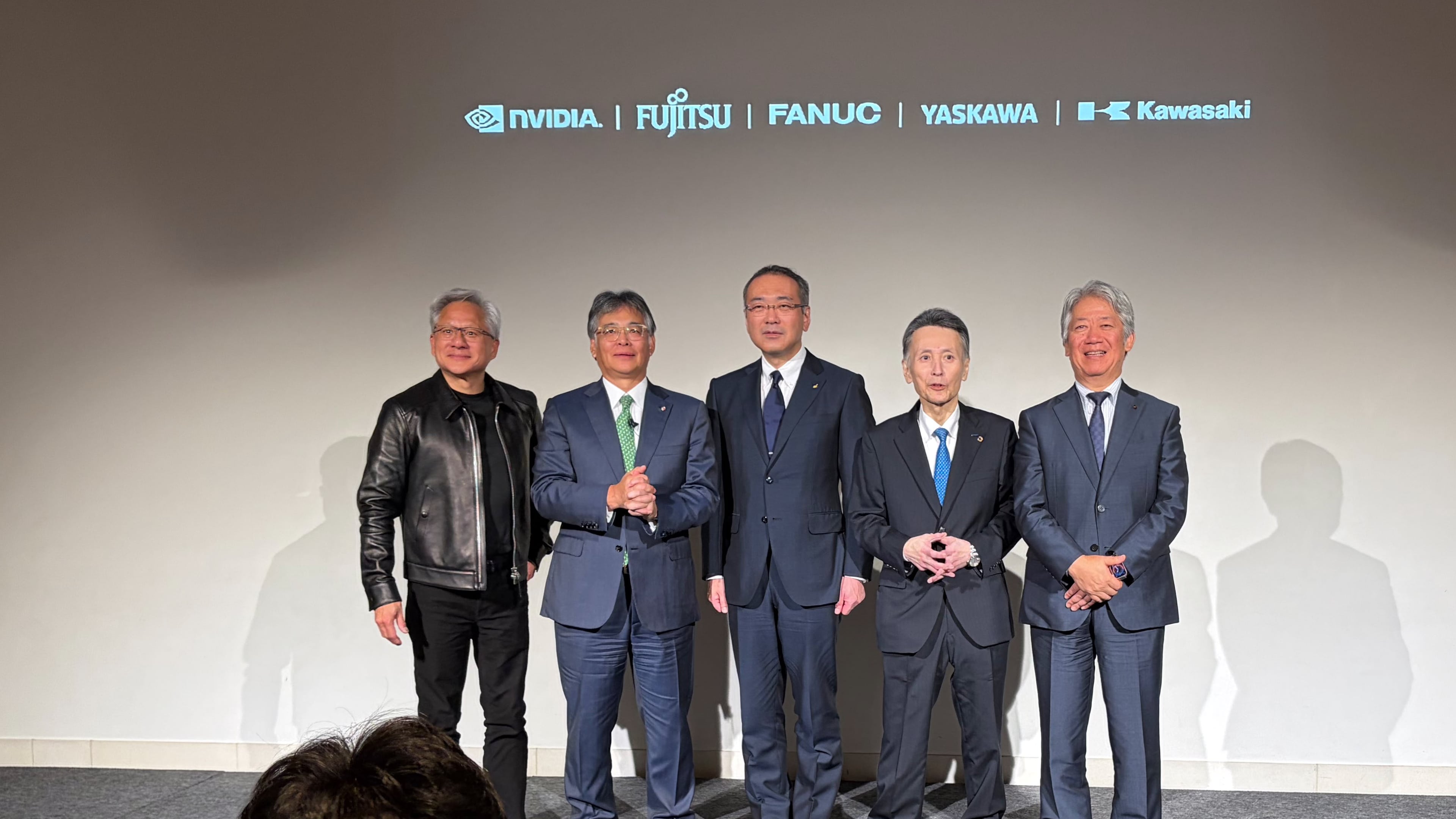 From left, Nvidia CEO Jensen Huang, Fujitsu CEO Takahito Tokita, Fanuc CEO Kenji Yamaguchi, Yaskawa CEO Masahiro Ogawa and Kawasaki Heavy CEO Yasuhiko Hashimoto pose for the media at an event to announce a new initiative in Tokyo, Thursday, July 16, 2026. (AP Photo/Yuri Kageyama)