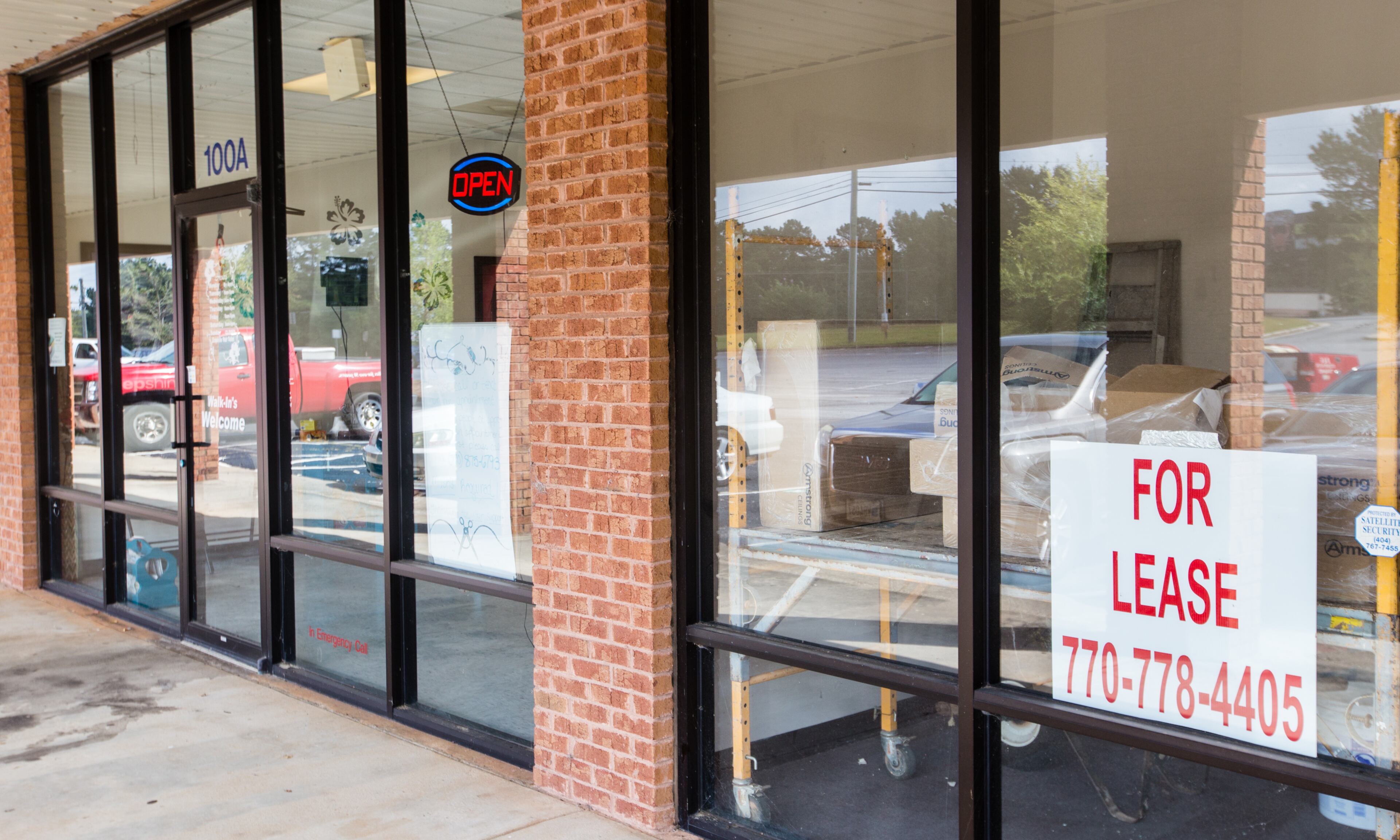 Exquisite Hair Salon, at left, is open for business but the neighboring suite, once home to Hampton Family Practice, is now vacant. Exquisite owner Tishonnia Gross says that she has lost stylists who fear catching the virus while cutting or coloring hair. (Jenni Girtman for The Atlanta Journal-Constitution)