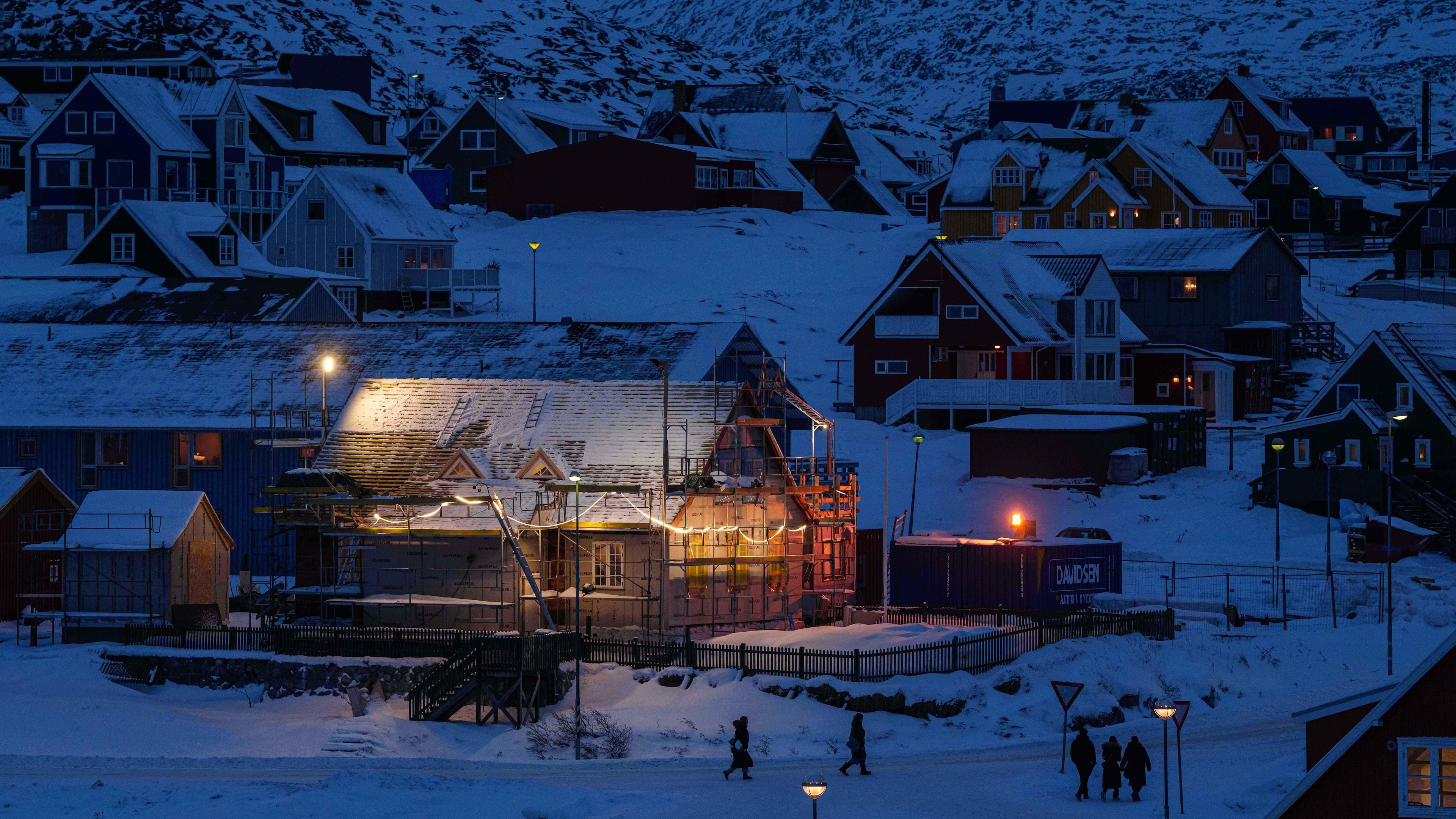 People walk along a street in downtown of Nuuk, Greenland, on Tuesday, Jan. 13, 2026. (AP Photo/Evgeniy Maloletka)