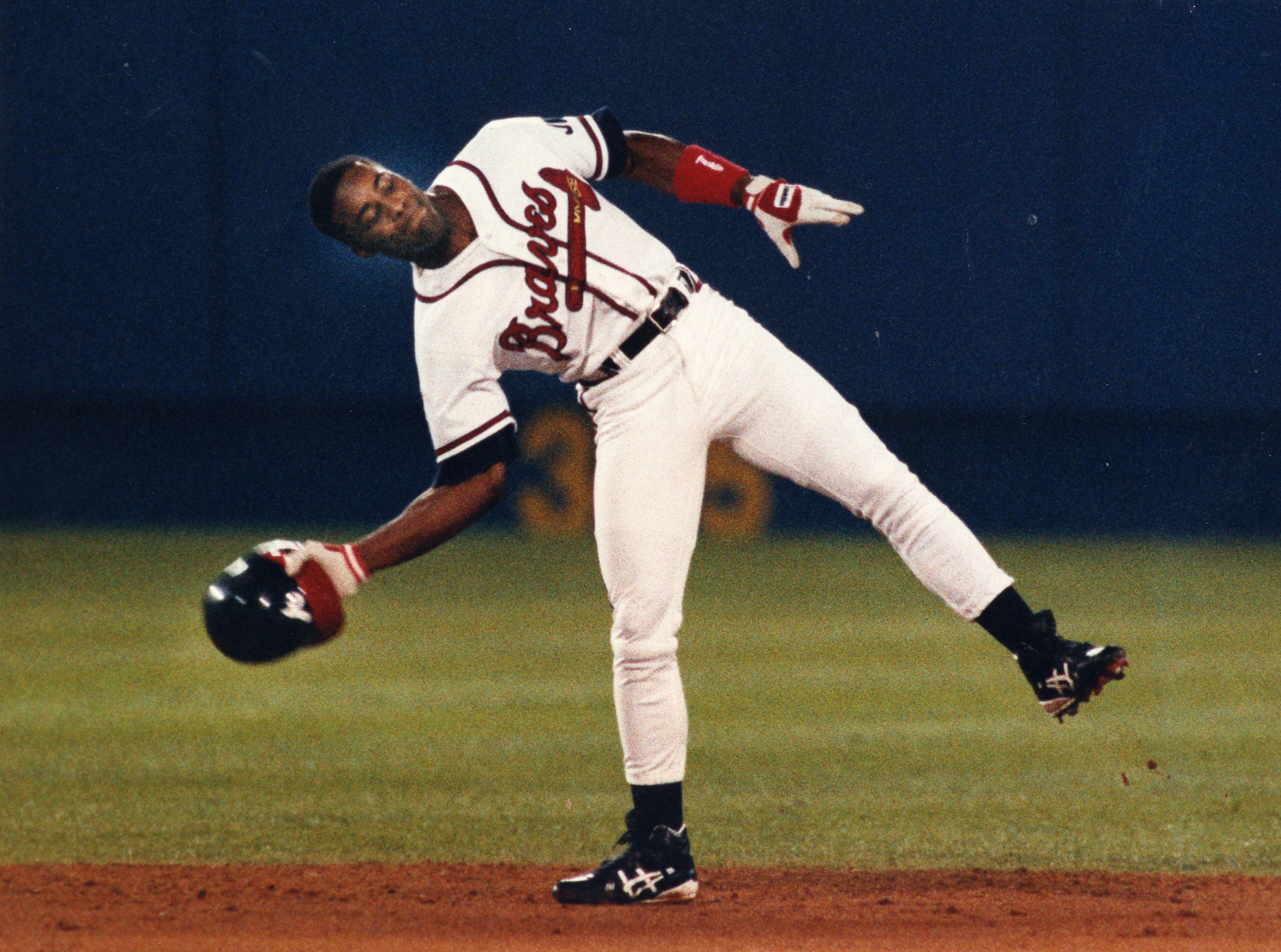 Ron Gant throws his helmet in disgust after he hit a pop up for an out in 1991. (Marlene Karas / AJC staff)