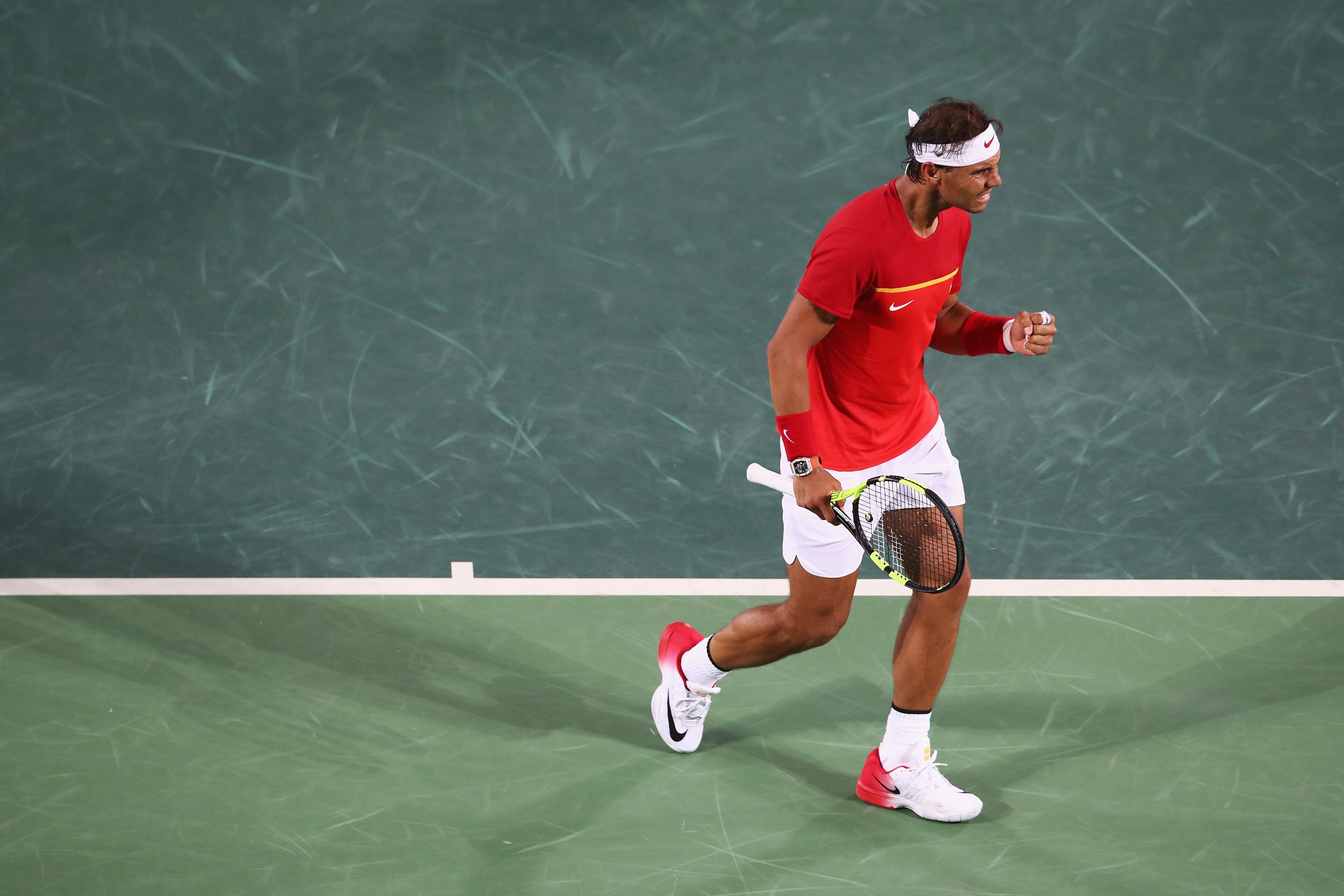 RIO DE JANEIRO, BRAZIL - AUGUST 12: Rafael Nadal of Spain celebrates a point in the Men's Doubles Gold medal match with Marc Lopez of Spain against Horia Tecau and Florin Mergea of Romania on Day 7 of the Rio 2016 Olympic Games at the Olympic Tennis Centre on August 12, 2016 in Rio de Janeiro, Brazil. (Photo by Mark Kolbe/Getty Images)