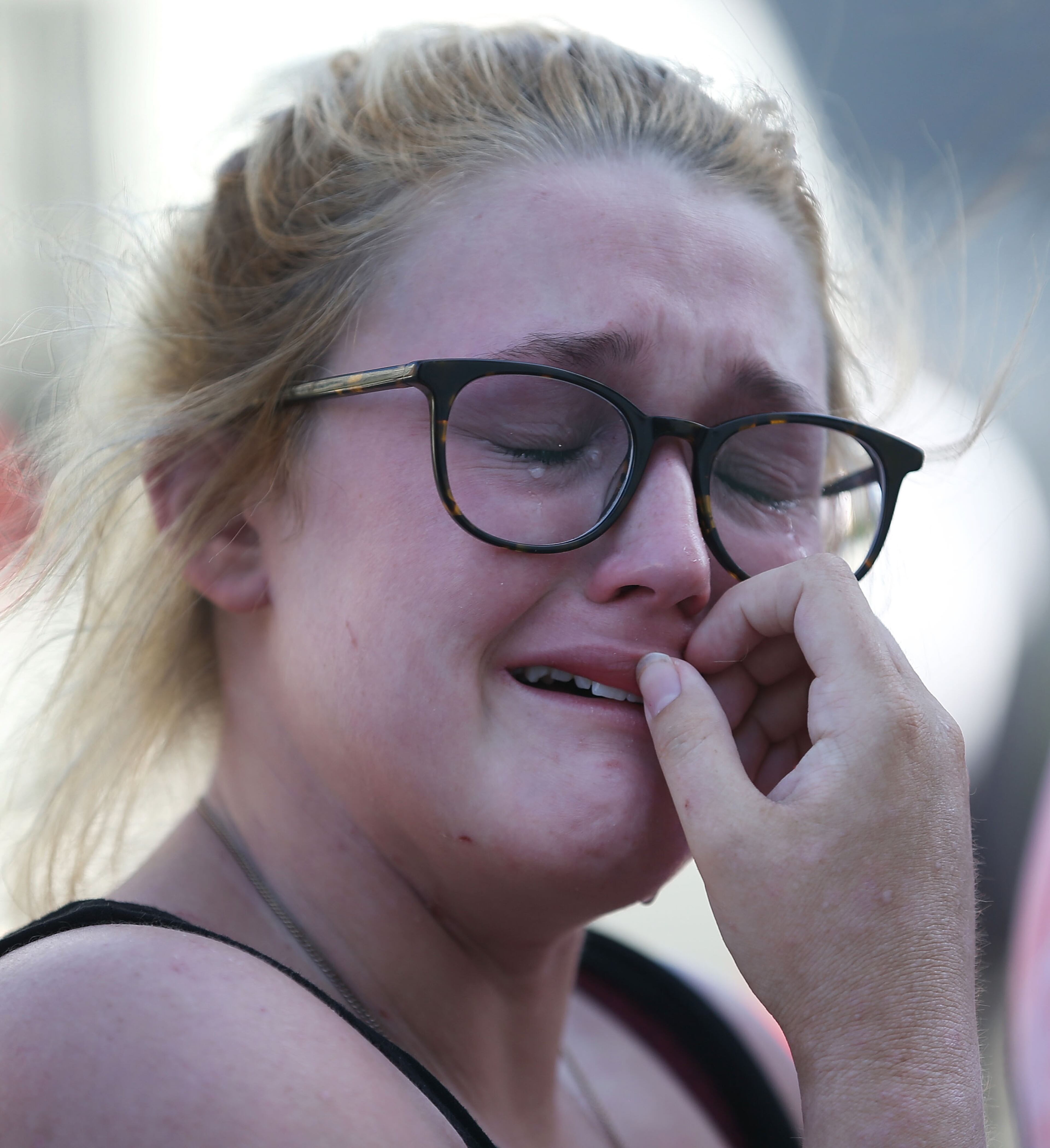 Kristen Roberts is overcome with emotion as she stop in front of the Emanuel African Methodist Episcopal Church after a mass shooting at the church that killed nine people on June 18, 2015, in Charleston, South Carolina. A 21-year-old suspect, Dylann Roof of Lexington, South Carolina, was arrersted Thursday during a traffic stop. Emanuel AME Church is one of the oldest in the South. (Photo by Joe Raedle/Getty Images)