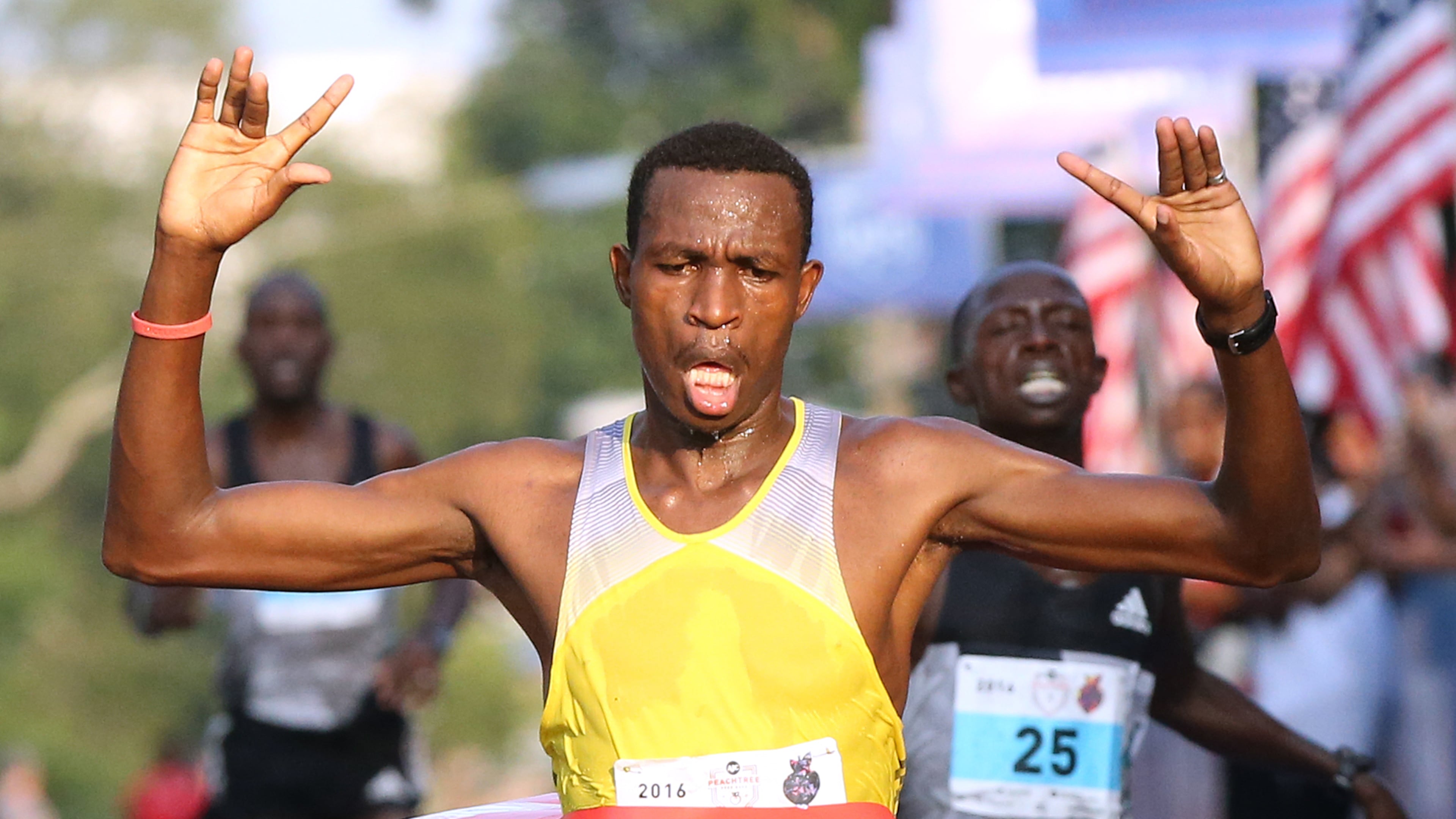 Gabriel Geay (front to back) wins the three-way race to the finish line, beating Daniel Salel and Philip Langat to win the 47th running of the AJC Peachtree Road Race at Piedmont Park on Monday, July 4, 2016, in Atlanta. Curtis Compton / ccompton@ajc.com