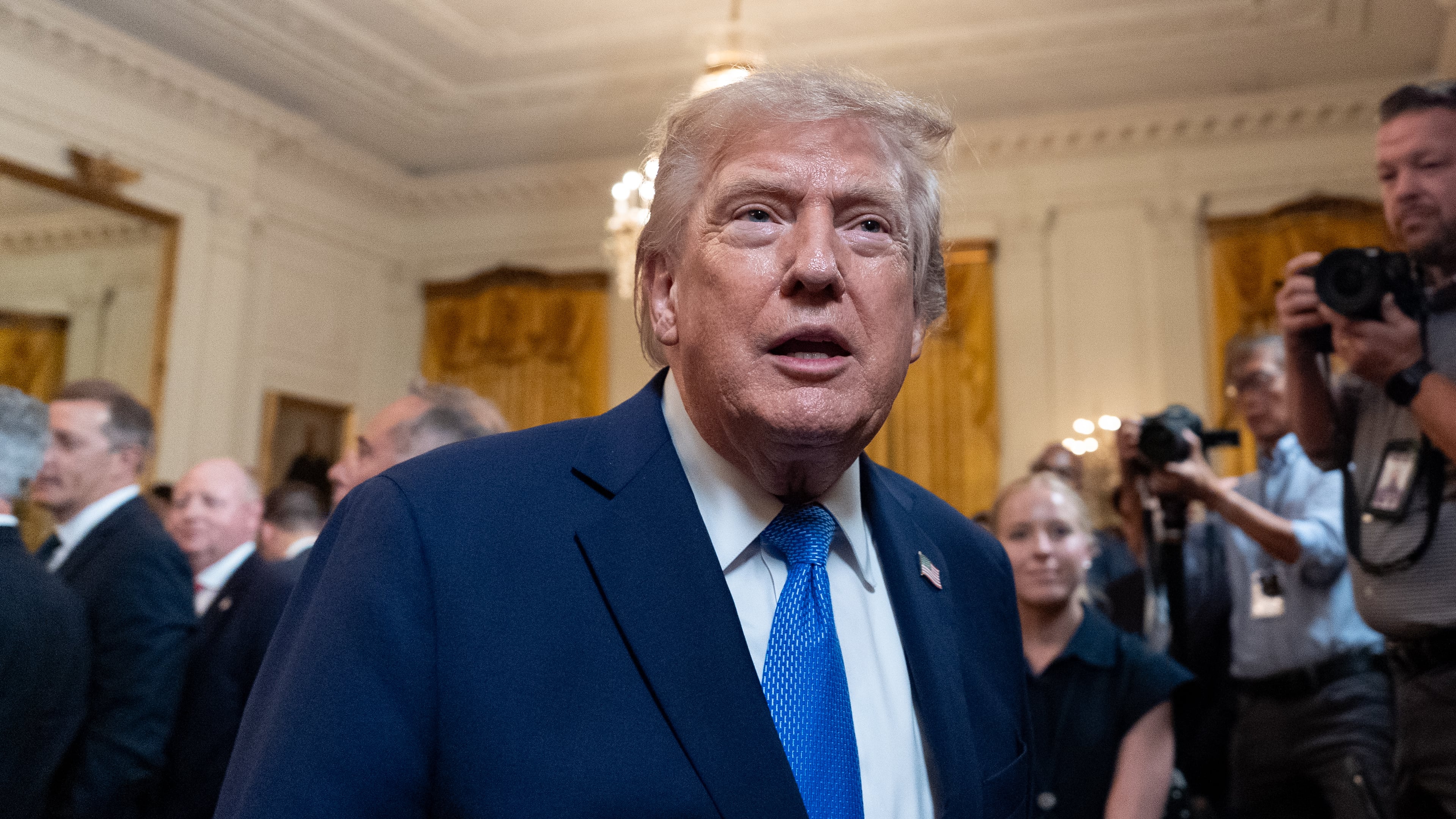 President Donald Trump speaks with a reporter as he departs after an event for Olympic athletes, coaches, staff, and representatives from Team USA in the East Room of the White House, Thursday, Aug. 6, 2026, in Washington. (AP Photo/Alex Brandon)