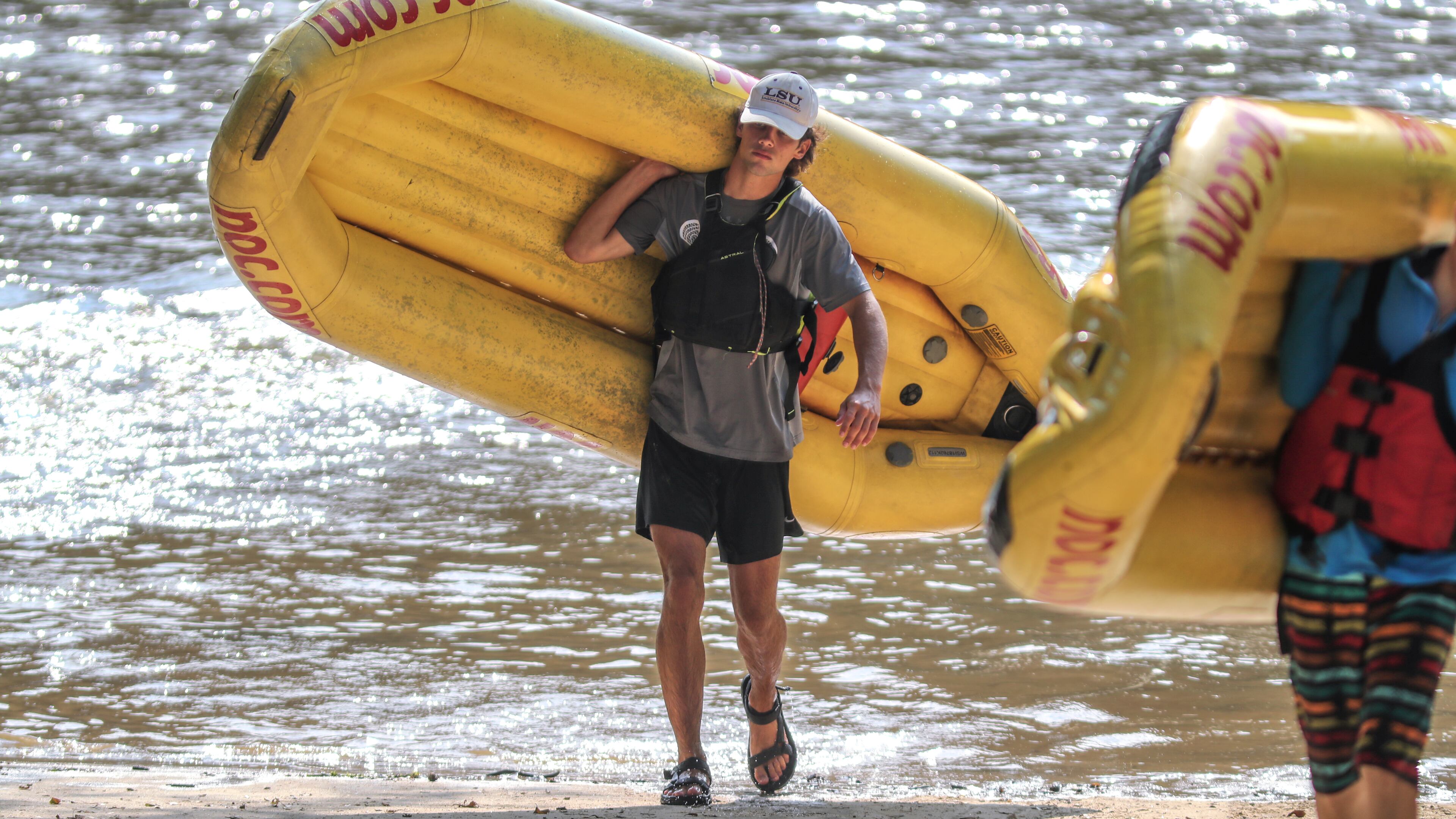 Roswell High School graduate, Brock Maddux-18 waited for rafters to finish their trip on Wednesday, Aug. 11, 2021 at the Paces Mill boat ramp on the Chattahoochee River as part of his summer job as a guide with the Nantahala Outdoor Center. (John Spink / John.Spink@ajc.com)