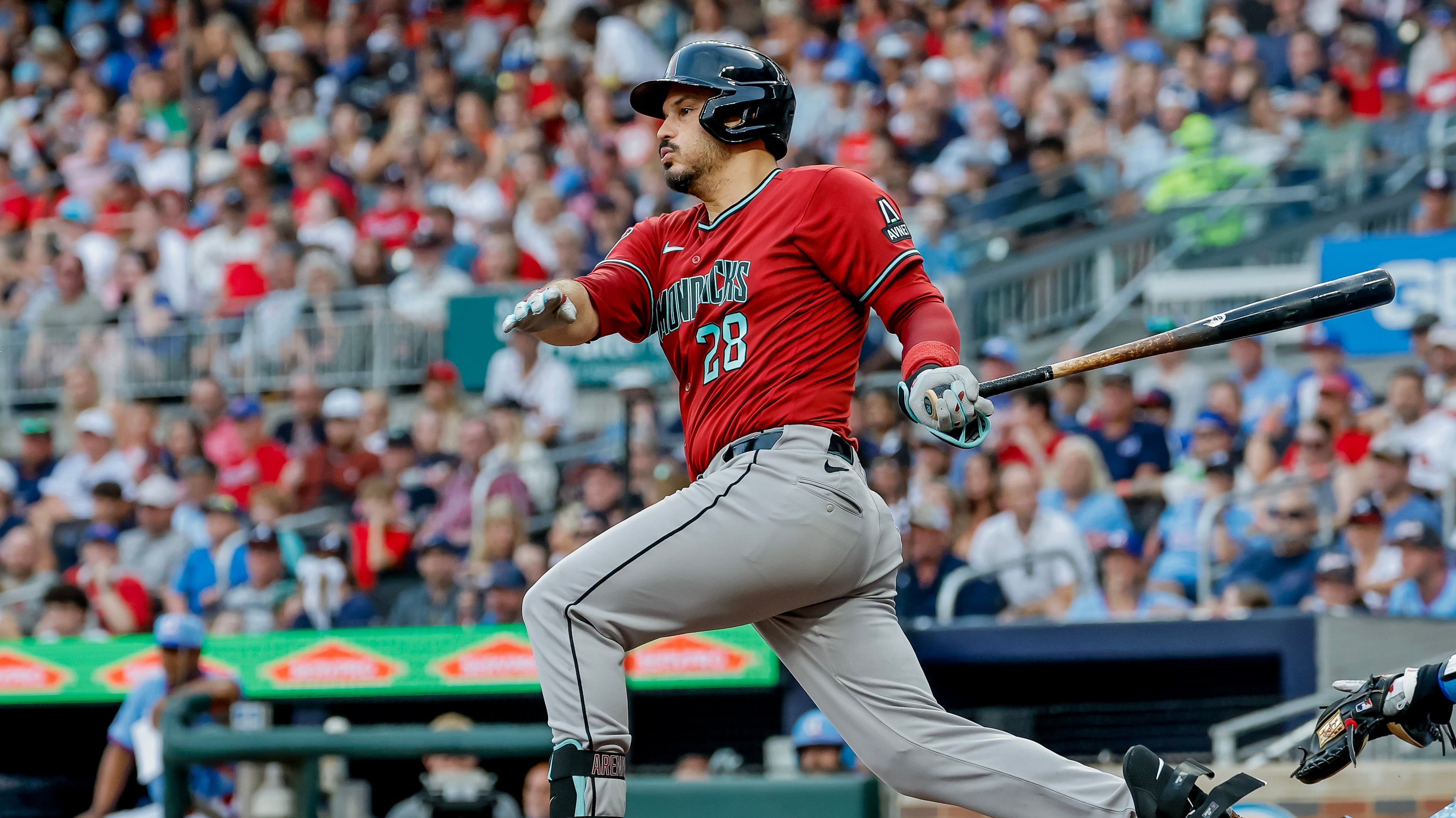 Arizona Diamondbacks third baseman Nolan Arenado (28) follows through on an RBI grounder against the Atlanta Braves during the second inning of a baseball game, Saturday, August 15, 2026, in Atlanta. (AP Photo/Erik S. Lesser)