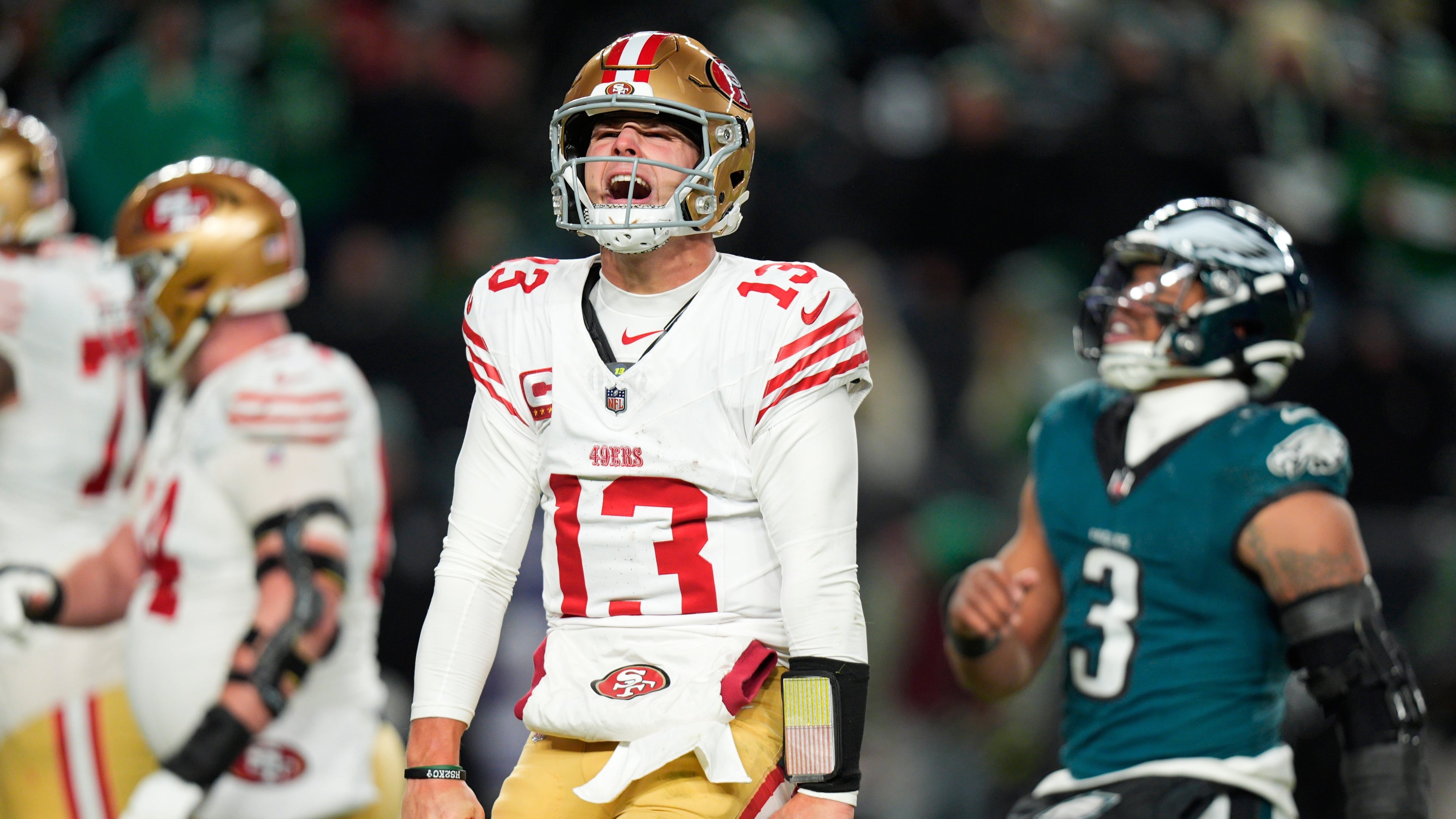 San Francisco 49ers quarterback Brock Purdy (13) reacts to a touchdown pass to 49ers running back Christian McCaffrey during the second half of an NFL wild-card playoff football game against the Philadelphia Eagles on Sunday, Jan. 11, 2026, in Philadelphia. (AP Photo/Chris Szagola)