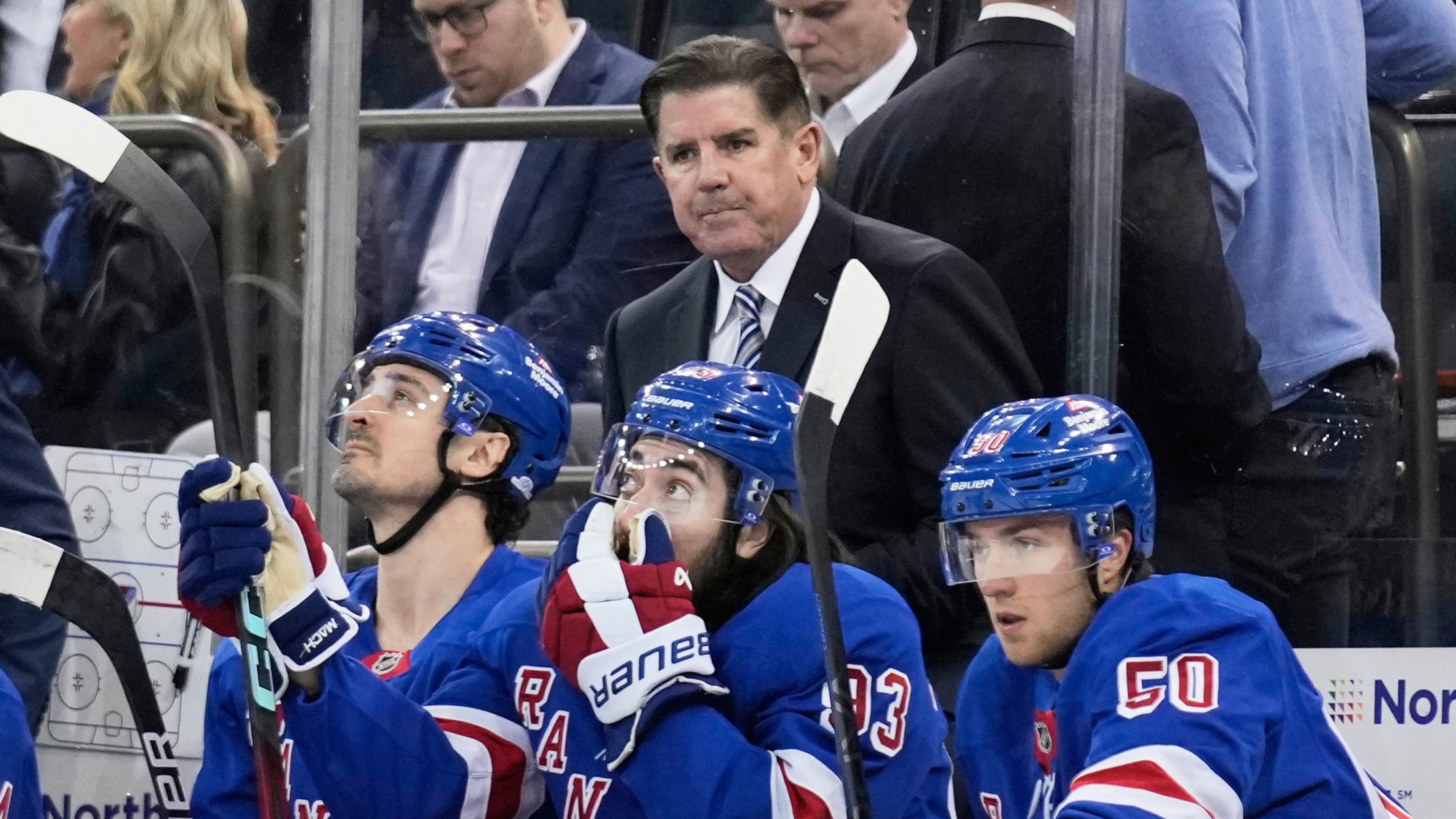 FILE - New York Rangers coach Peter Laviolette, top, watches during the first period of an NHL hockey game against the Tampa Bay Lightning in New York, April 17, 2025. (AP Photo/Seth Wenig, File)