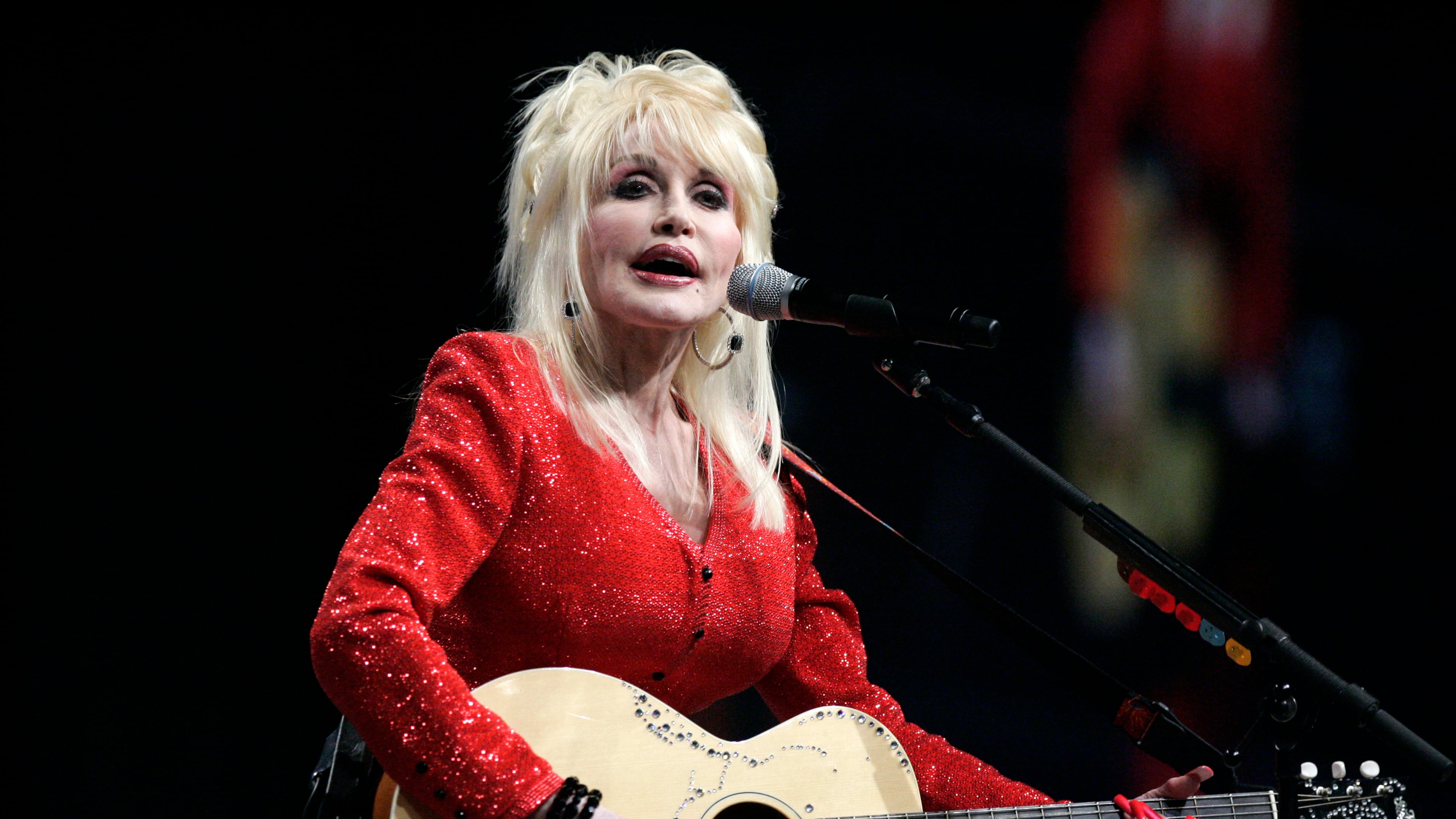 FILE - Dolly Parton performs at a United Way of America convention in Detroit, Friday, May 15, 2009. (AP Photo/Carlos Osorio, File)