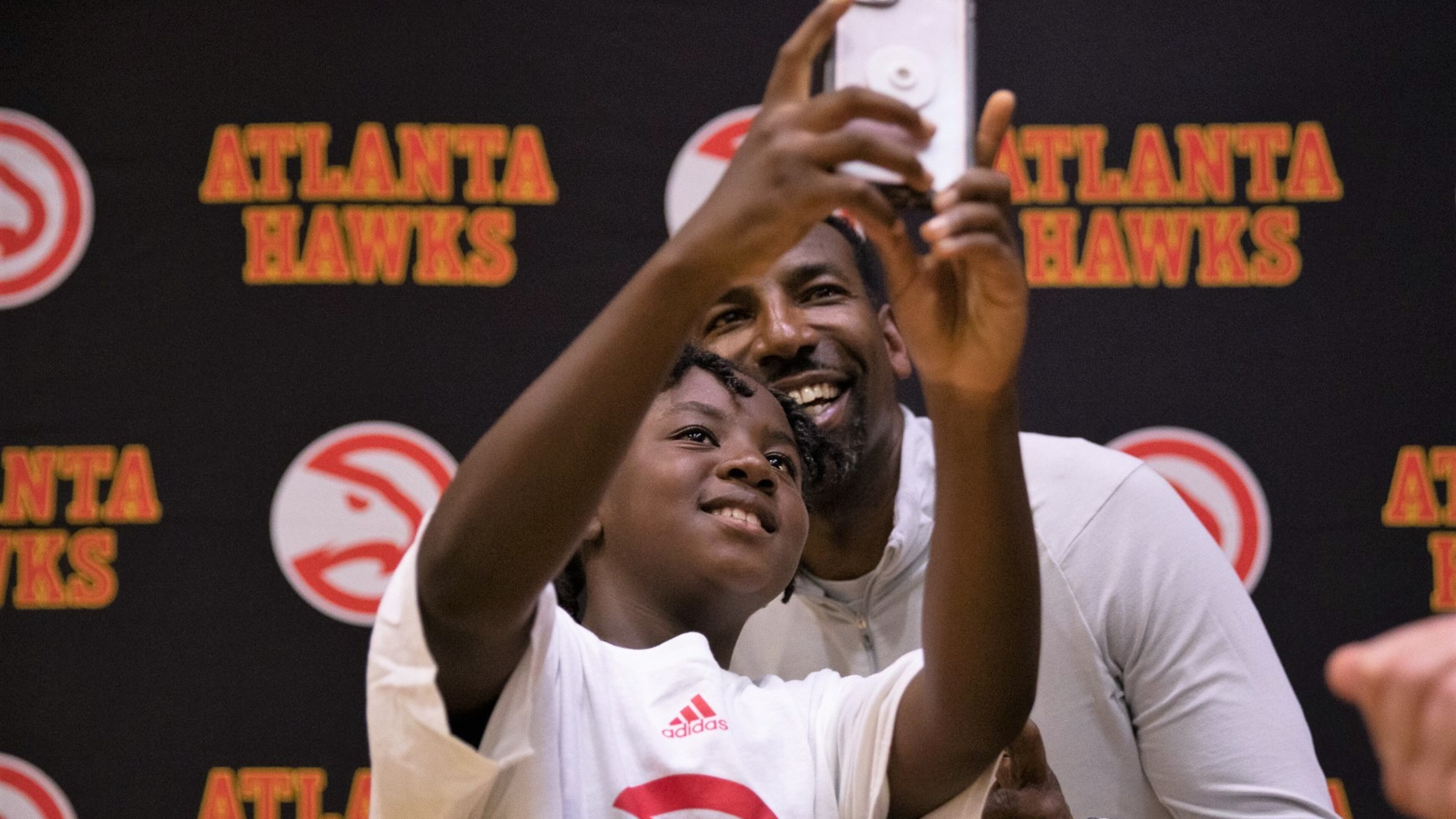 Atlanta Mayor Andre Dickens poses for a selfie at the championship game of the fourth season of Midnight Basketball at the C.T. Martin Recreational Center on June 14, 2023. The program is part of his effort to curb youth violence.
