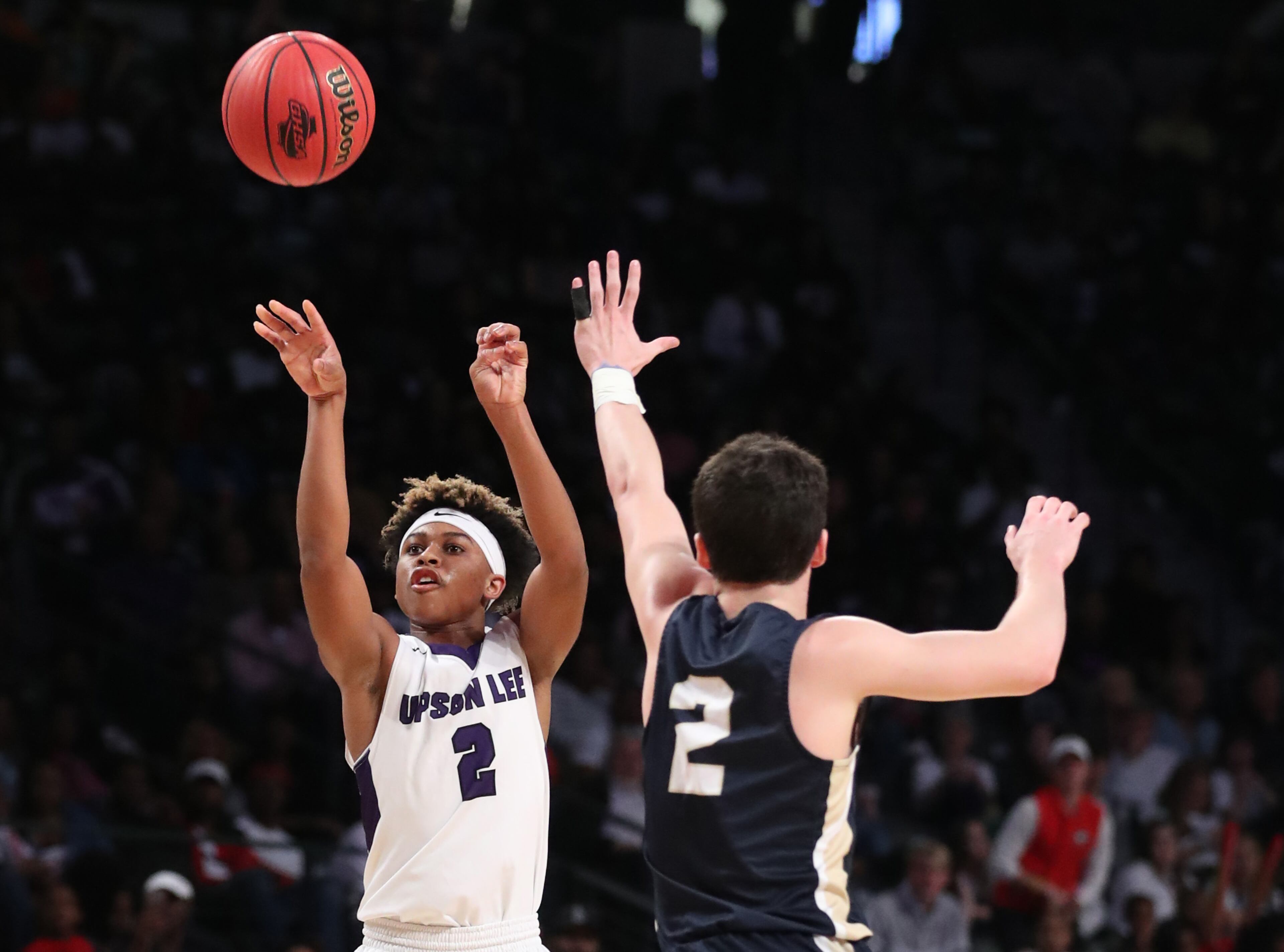 March 10, 2018 - Atlanta, Ga: Upson-Lee guard Cameron Traylor (2) attempts a three-point basket against St. Pius guard Brian Gonzalo (2) during the first half of the GHSA Class AAAA Boys State Championship at McCamish Pavilion Saturday, March 10, 2018, in Atlanta. PHOTO / JASON GETZ