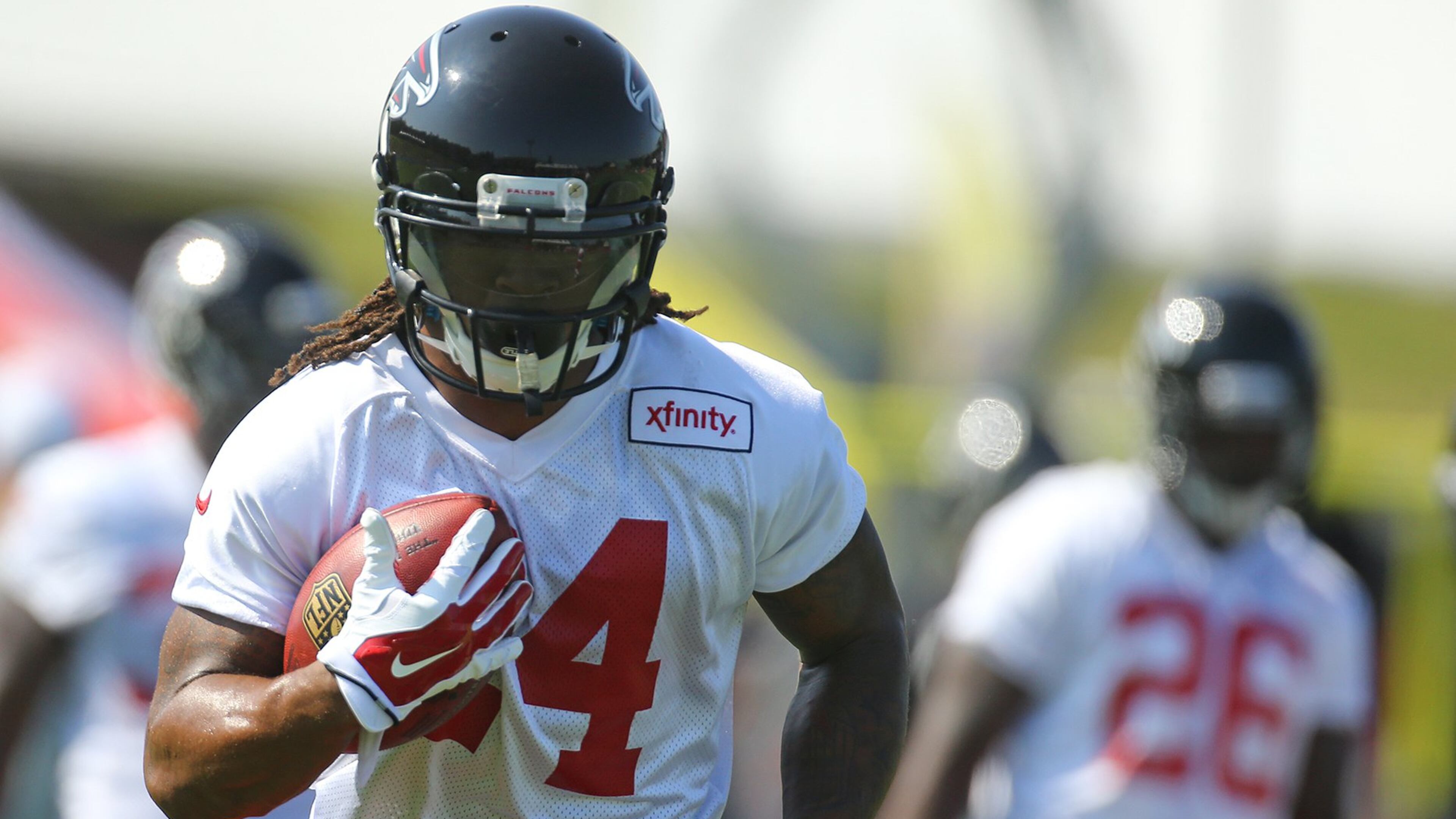 073115 FLOWERY BRANCH: Falcons running back Tevin Coleman (right) looks on as Devonta Freeman runs a drill on the first day of training camp on Friday, July 31, 2015, in Flowery Branch. Curtis Compton / ccompton@ajc.com
