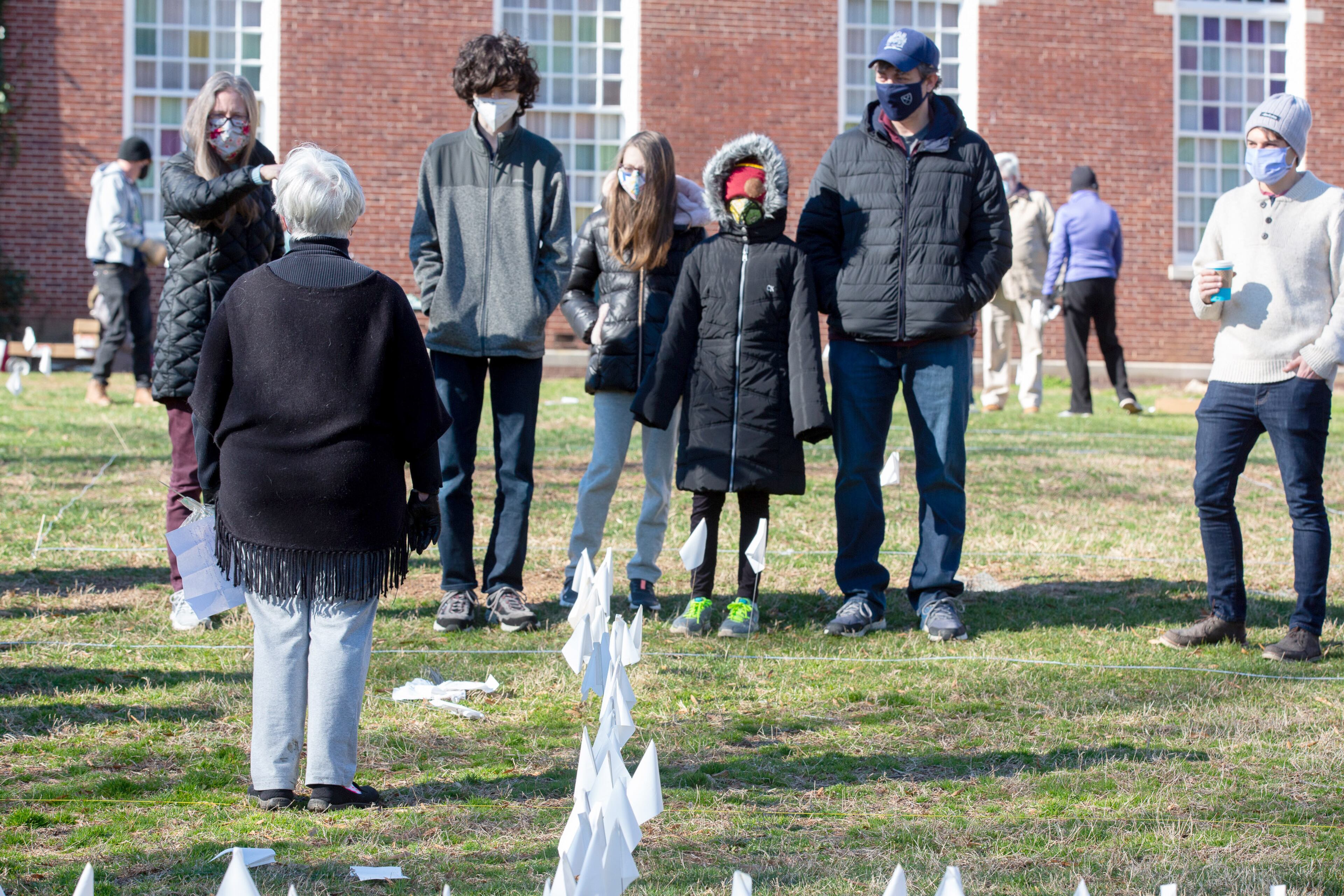 The Rev. Diane Dougherty gives volunteers instructions before they start to plant 15,000 flags that represent Georgia's COVID-19 deaths, on the lawn of First Christian Church of Decatur on Saturday, February 20, 2021. (Photo: Steve Schaefer for The Atlanta Journal-Constitution)