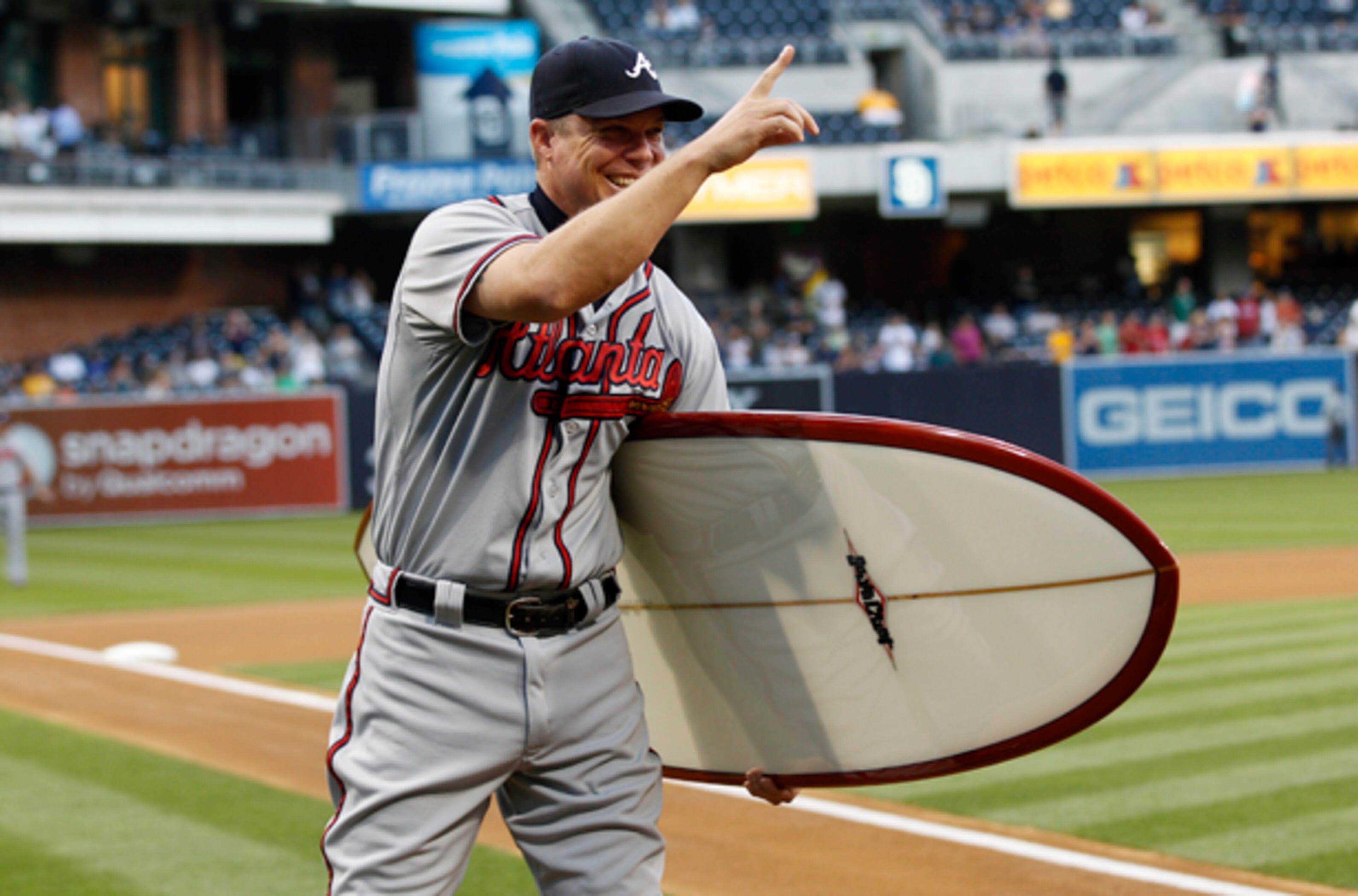 Aug. 27: Chipper Jones acknowledges the San Diego Padres bench after being presented a surf board in recognition of his 20 years in baseball in San Diego.