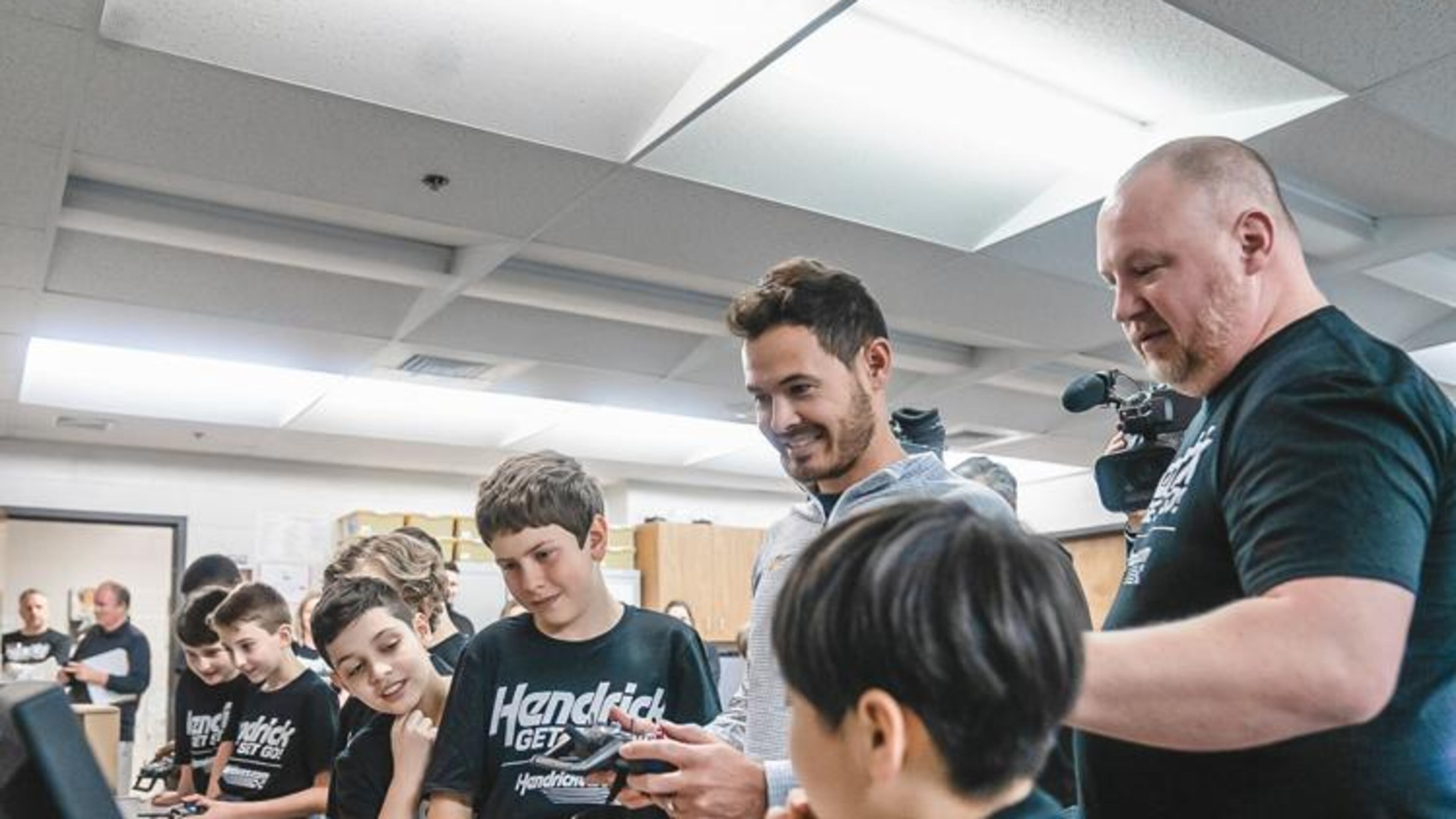 NASCAR Cup Series champion Kyle Larson smiles as he tours a STEM classroom at Harmony Elementary in Buford. (Courtesy of Sheer+Candid)