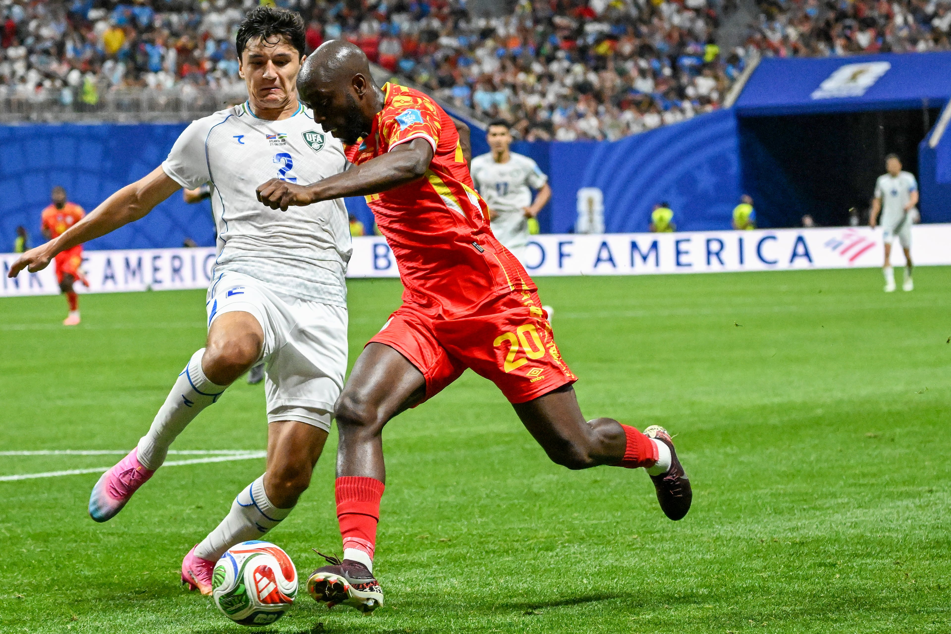 Uzbekistan defender Abdukodir Khusanov (left) and Congo forward Yoane Wissa (right) battle for control during the first half of a FIFA World Cup match at Atlanta Stadium (Mercedes-Benz Stadium) on Saturday, June 27, 2026, in Atlanta. (Hyosub Shin/AJC)