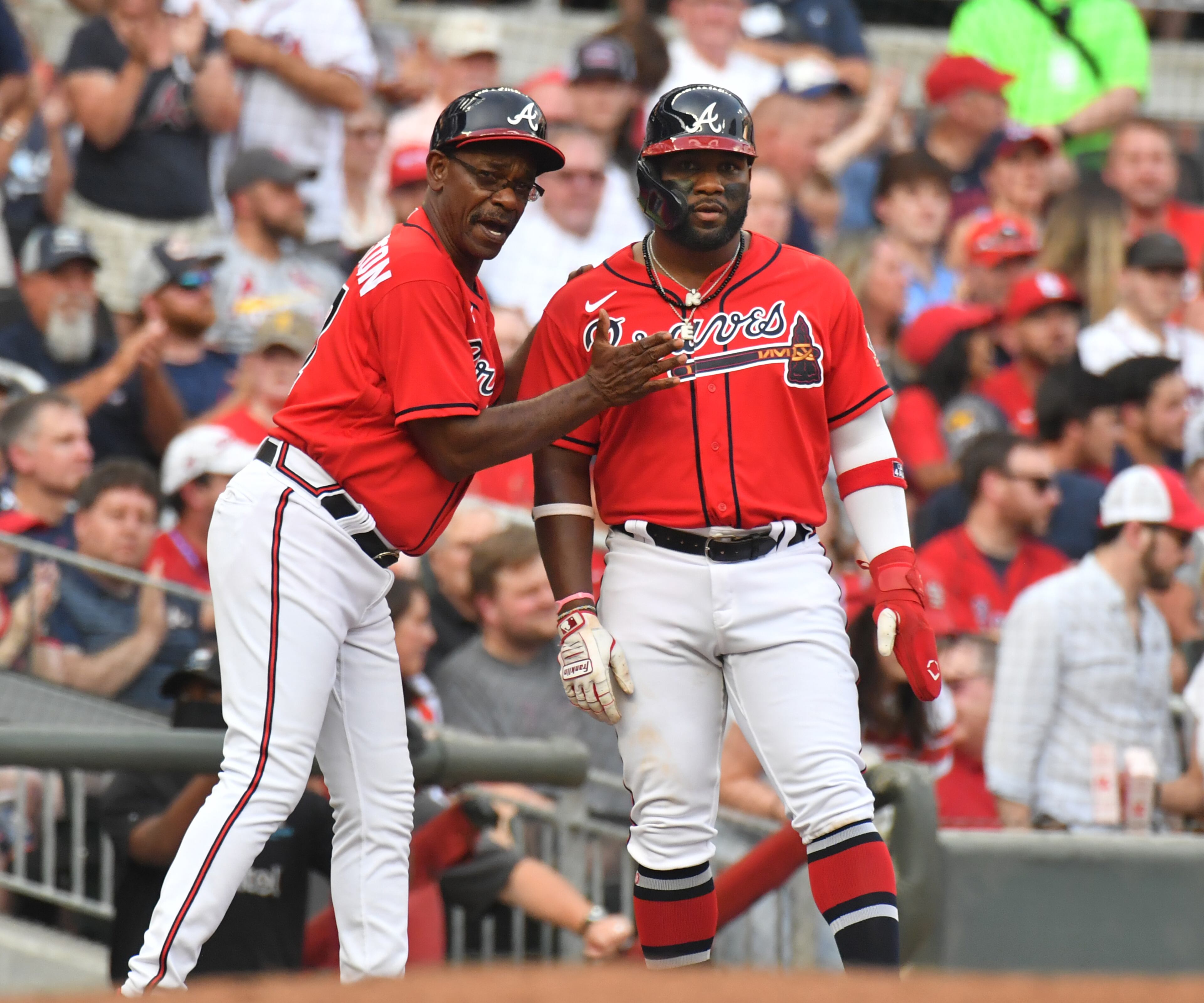 Braves right fielder Abraham Almonte (right) is congratulated by third base coach Ron Washington in the first inning. (Hyosub Shin / Hyosub.Shin@ajc.com)