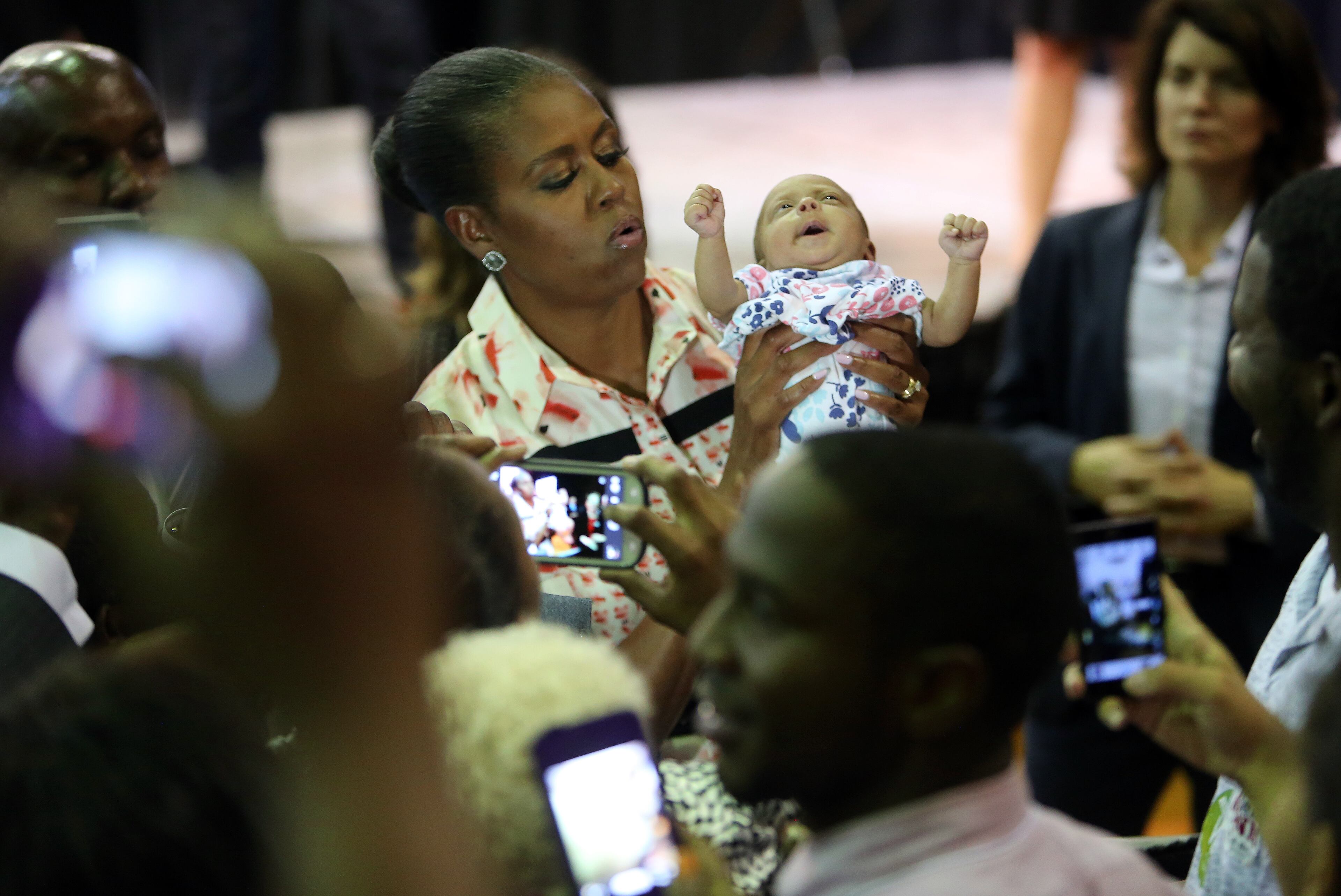 First Lady Michelle Obama lifts up 2-month-old Addison Bryant following a voter registration rally Monday evening Sept. 8, 2014, at the Martin Luther King Jr. Recreation Center in Atlanta. BEN GRAY / BGRAY@AJC.COM
