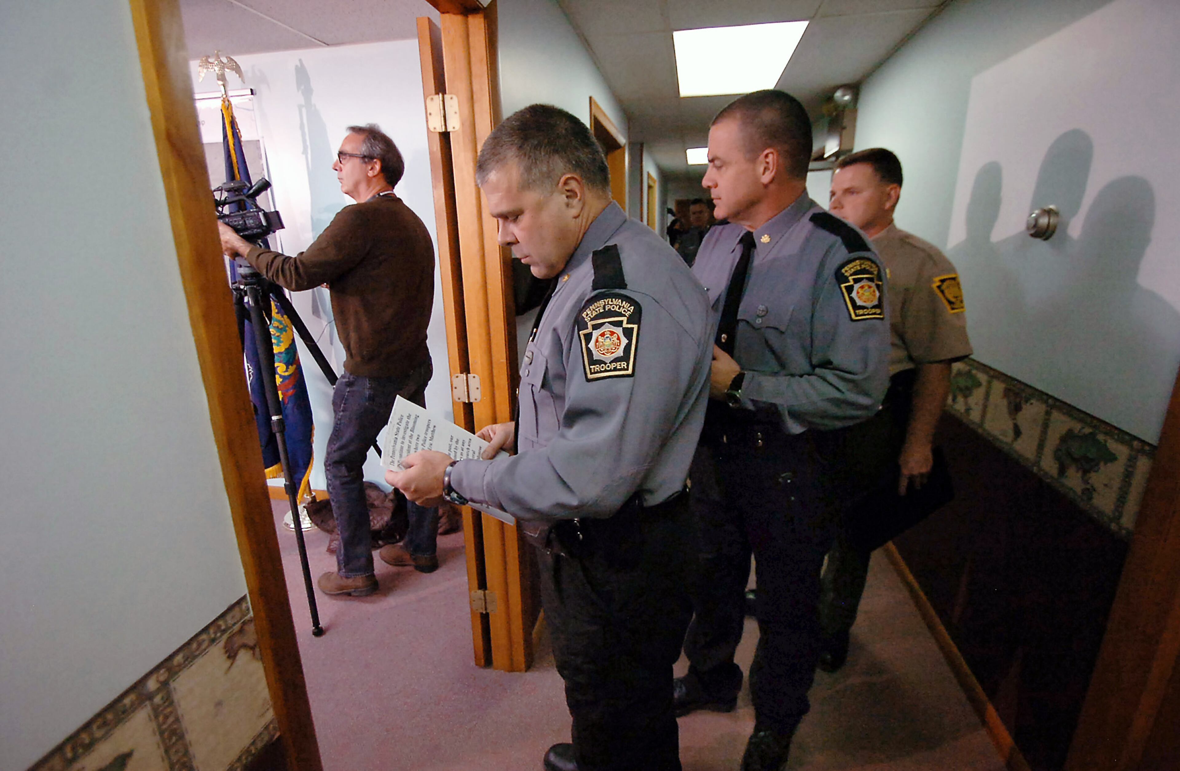 Pennsylvania State Police Lt. Col. George Bivens glances at his notes before a news conference, Friday, Oct. 3, 2014, at the Blooming Grove Township Municipal Building in Blooming Grove Township, Pa. Law enforcement officials tracking, Eric Fein, the survivalist charged with ambushing a rural Pennsylvania State Police barracks said Friday that they have found caches of food and other supplies and believe he'll likely start breaking into cabins or searching through trash bins to sustain himself. (AP Photo/The Scranton Times-Tribune, Butch Comegys) WILKES BARRE TIMES-LEADER OUT; MANDATORY CREDIT