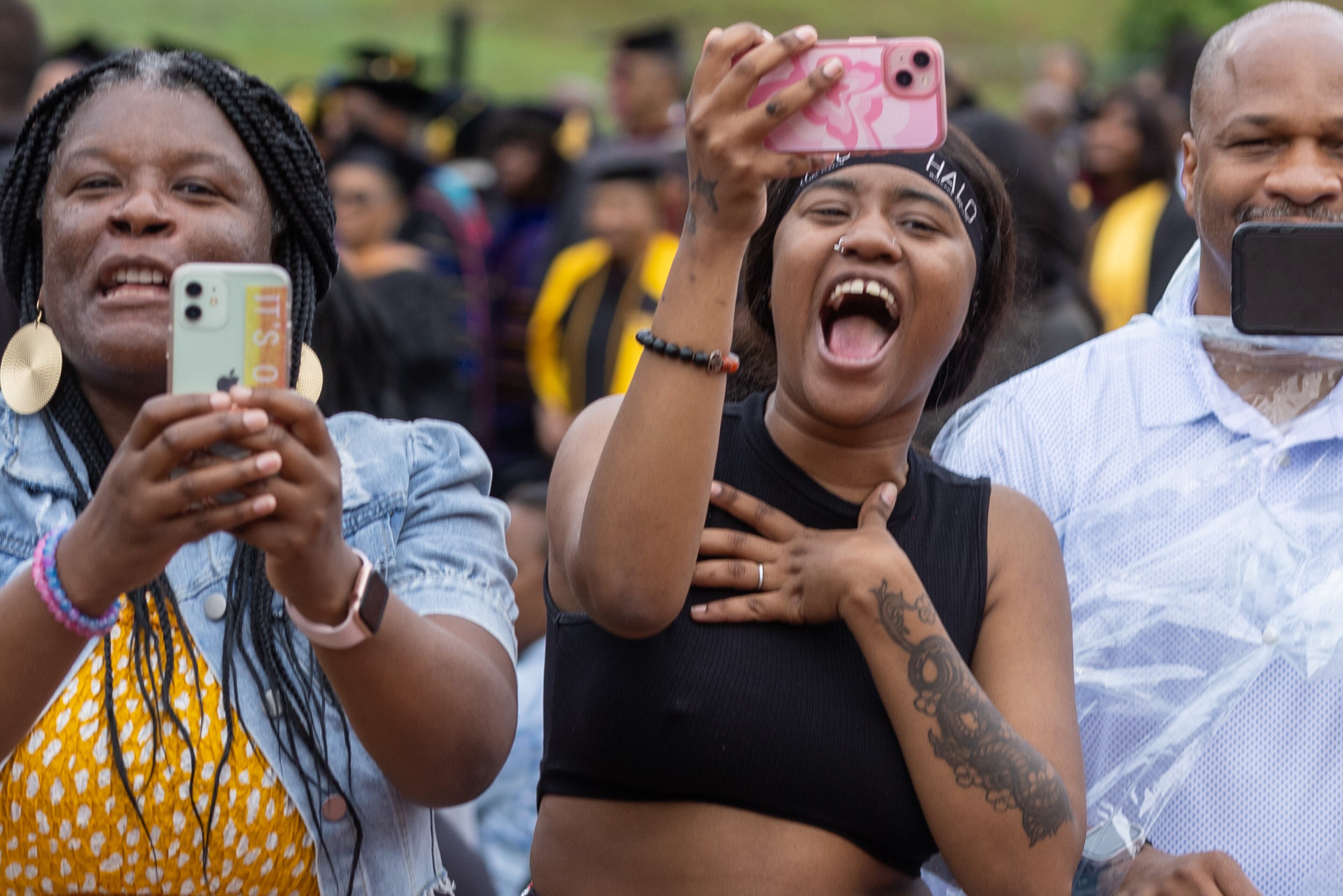 People try to get the attention of graduates in Panther Stadium during Clark Atlanta University's commencement ceremony Saturday, May 20, 2023. (Steve Schaefer / steve.schaefer@ajc.com)