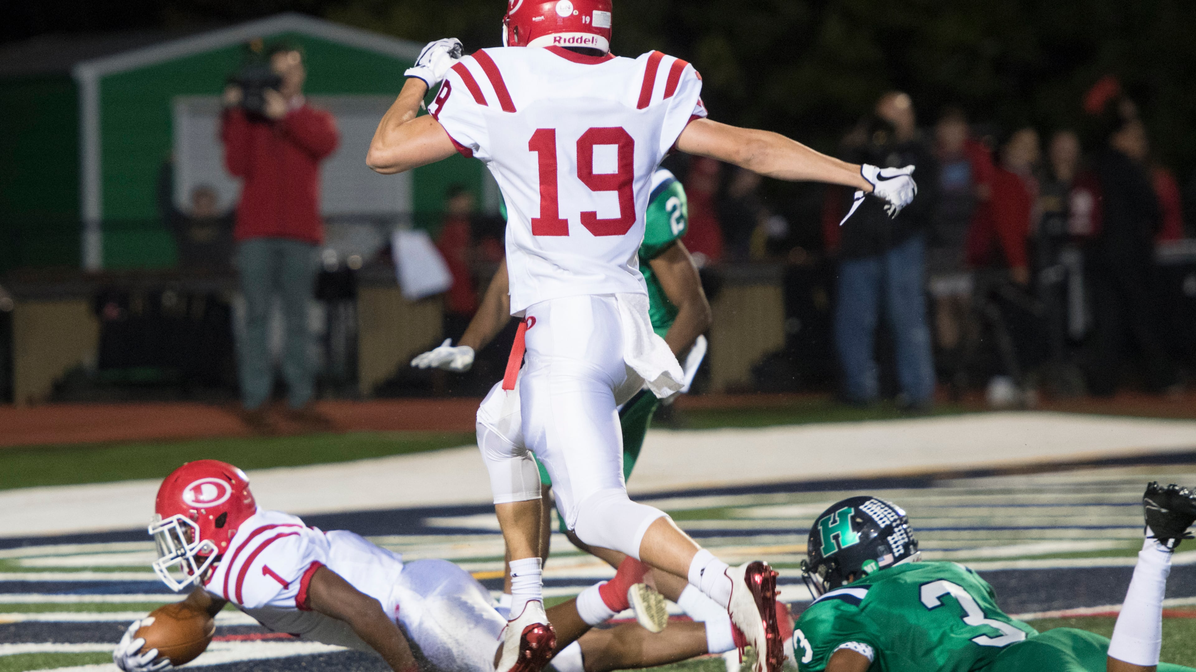 Dalton running back Jahmyr Gibbs (1) scores with Harrison cornerback Marquis Alston (3) on the ground and Chandler Starks (19) following behind during a high school football game on Thursday, Oct. 19, 2017, in Kennesaw, Ga. (Special to the Atlanta Journal-Constitution, John Amis )