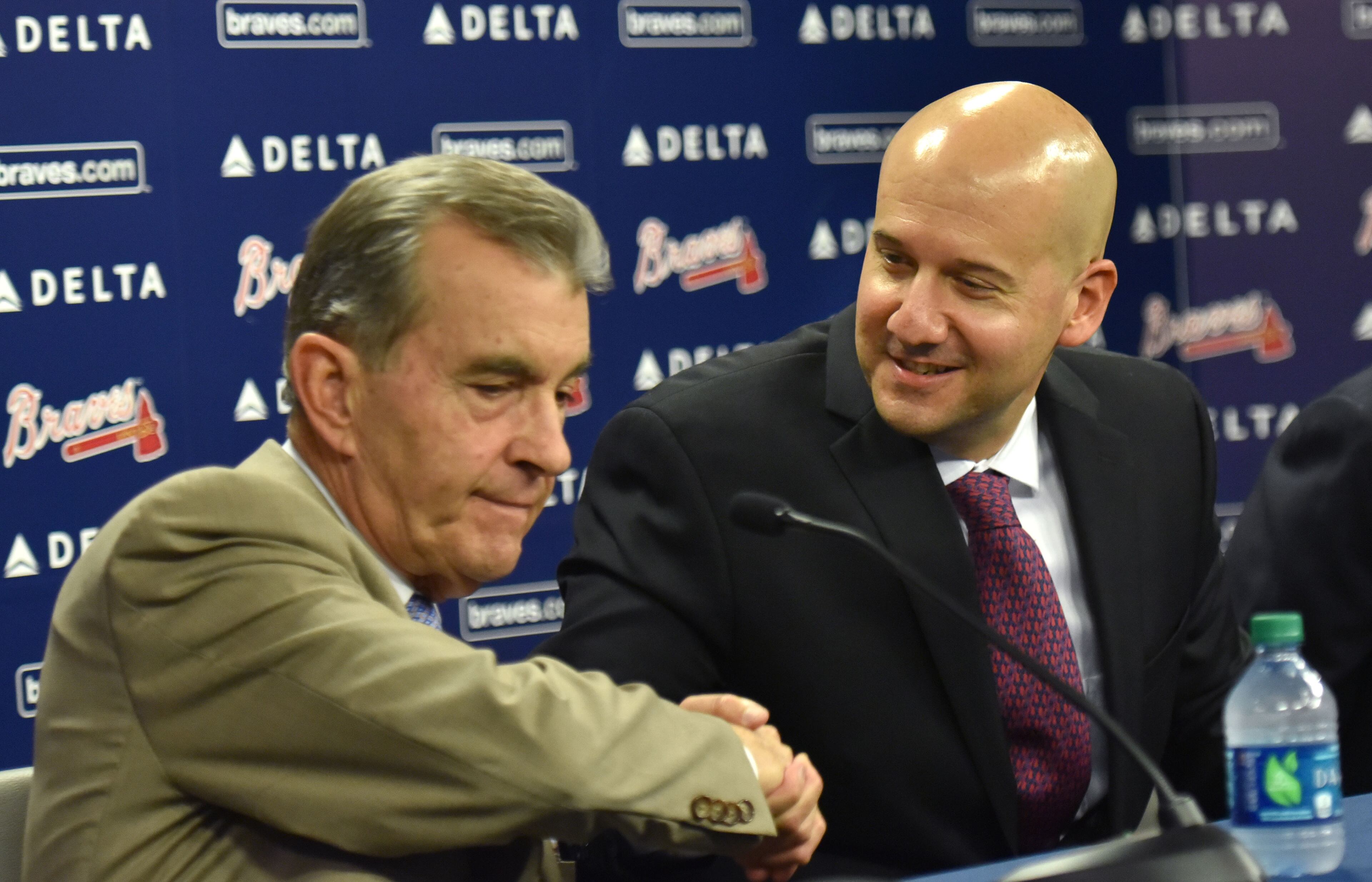 October 1, 2015 Atlanta - New general manager John Coppolella shakes hands with Atlanta Braves President John Schuerholz (left) after a press conference at Turner Field on Thursday, October 1, 2015. The Atlanta Braves have promoted John Coppolella to general manager following three seasons as assistant GM. The move was announced on Thursday by Braves president of baseball operations John Hart. The team said in a statement Coppolella has agreed to a four-year contract through the 2019 season, a term that will include the Braves' first three seasons at their new SunTrust Park. HYOSUB SHIN / HSHIN@AJC.COM