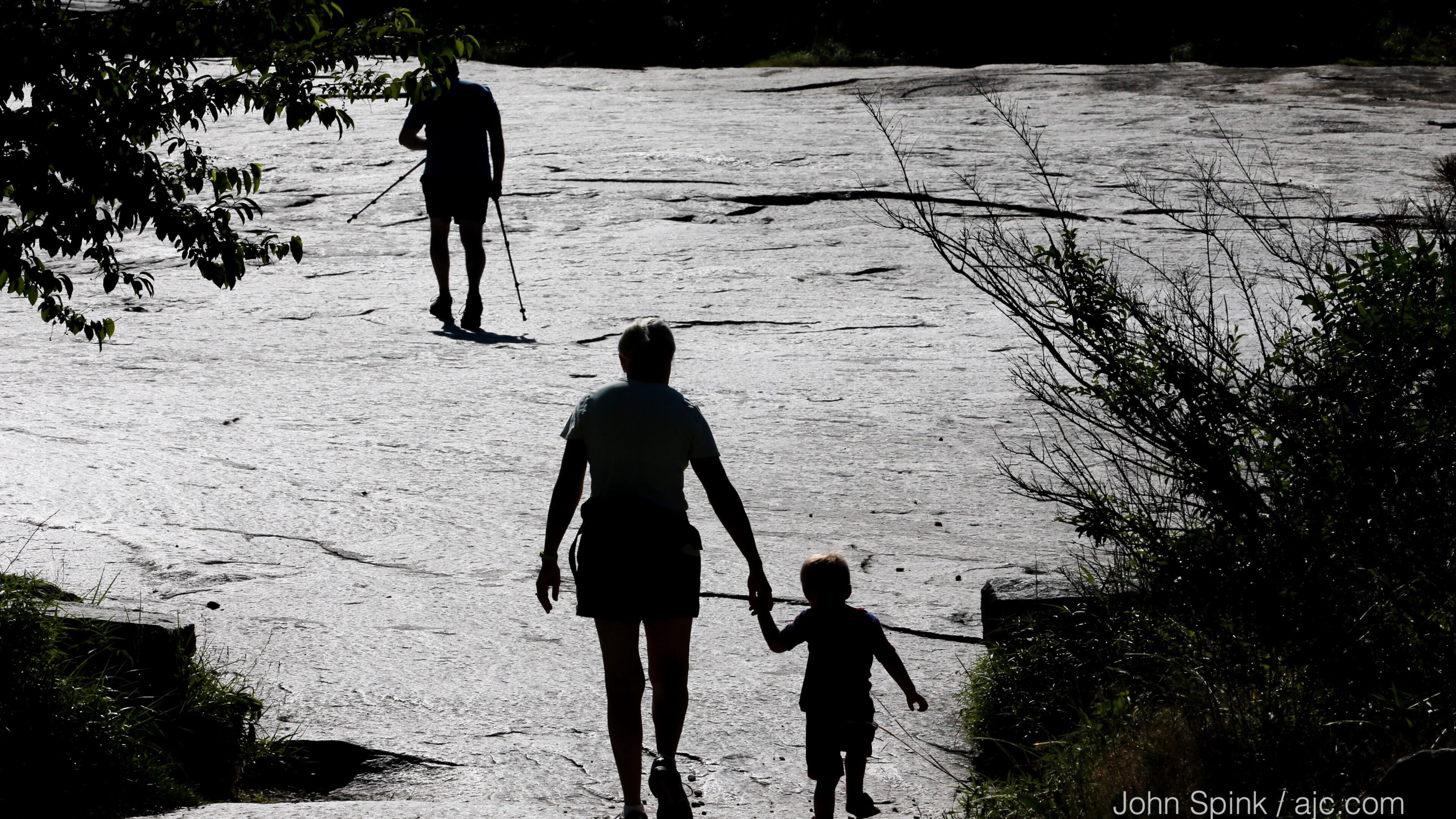 Cindy Wyss guides 3-year-old grandson Cameron Wyss up the walking trail at Stone Mountain on Wednesday. JOHN SPINK / JSPINK@AJC.COM