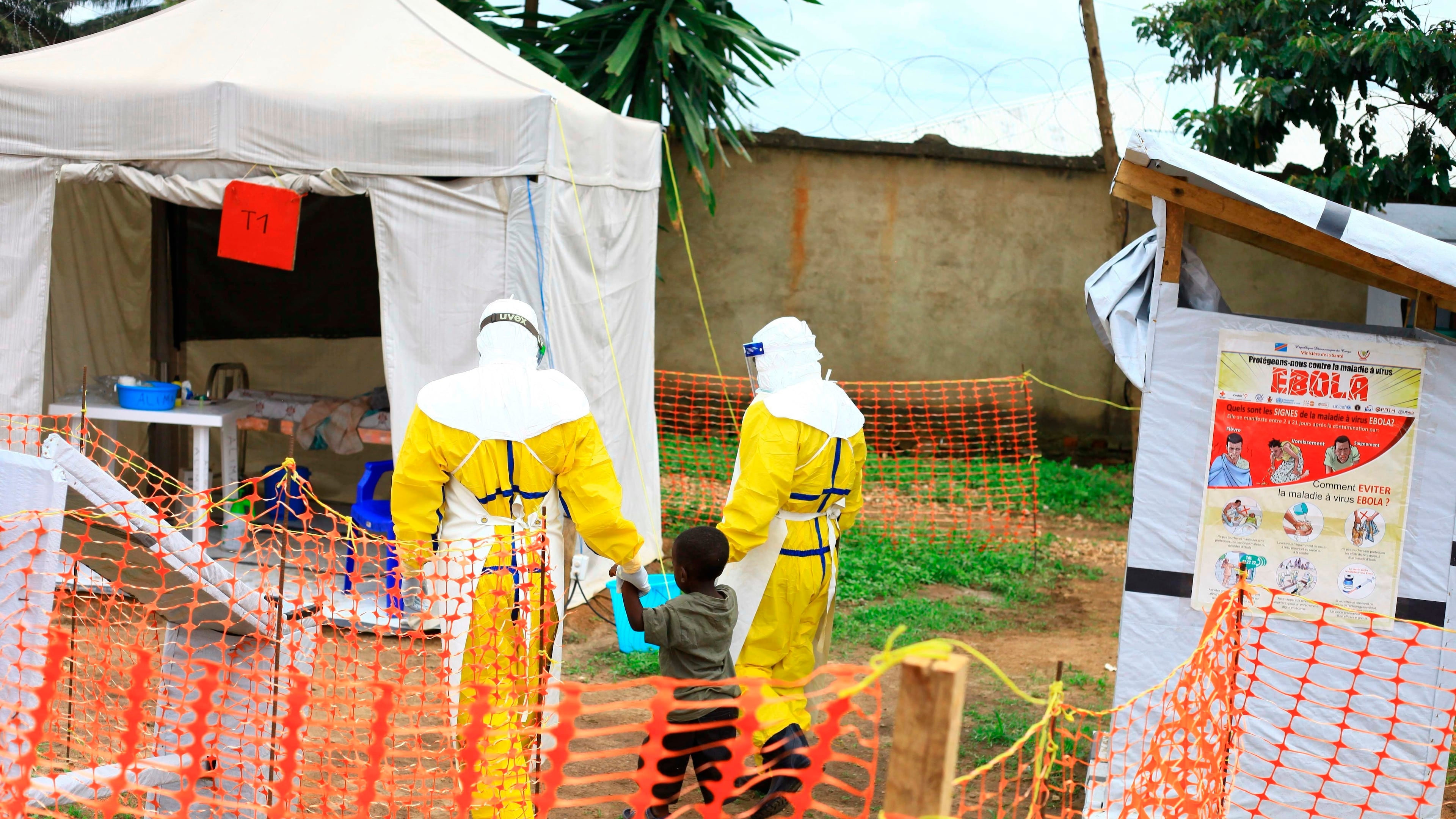 FILE - Health workers walk with a boy suspected of having the Ebola virus at an Ebola treatment center in Beni, eastern Congo, Sept 9, 2018. (AP Photo/Al-hadji Kudra Maliro, File)