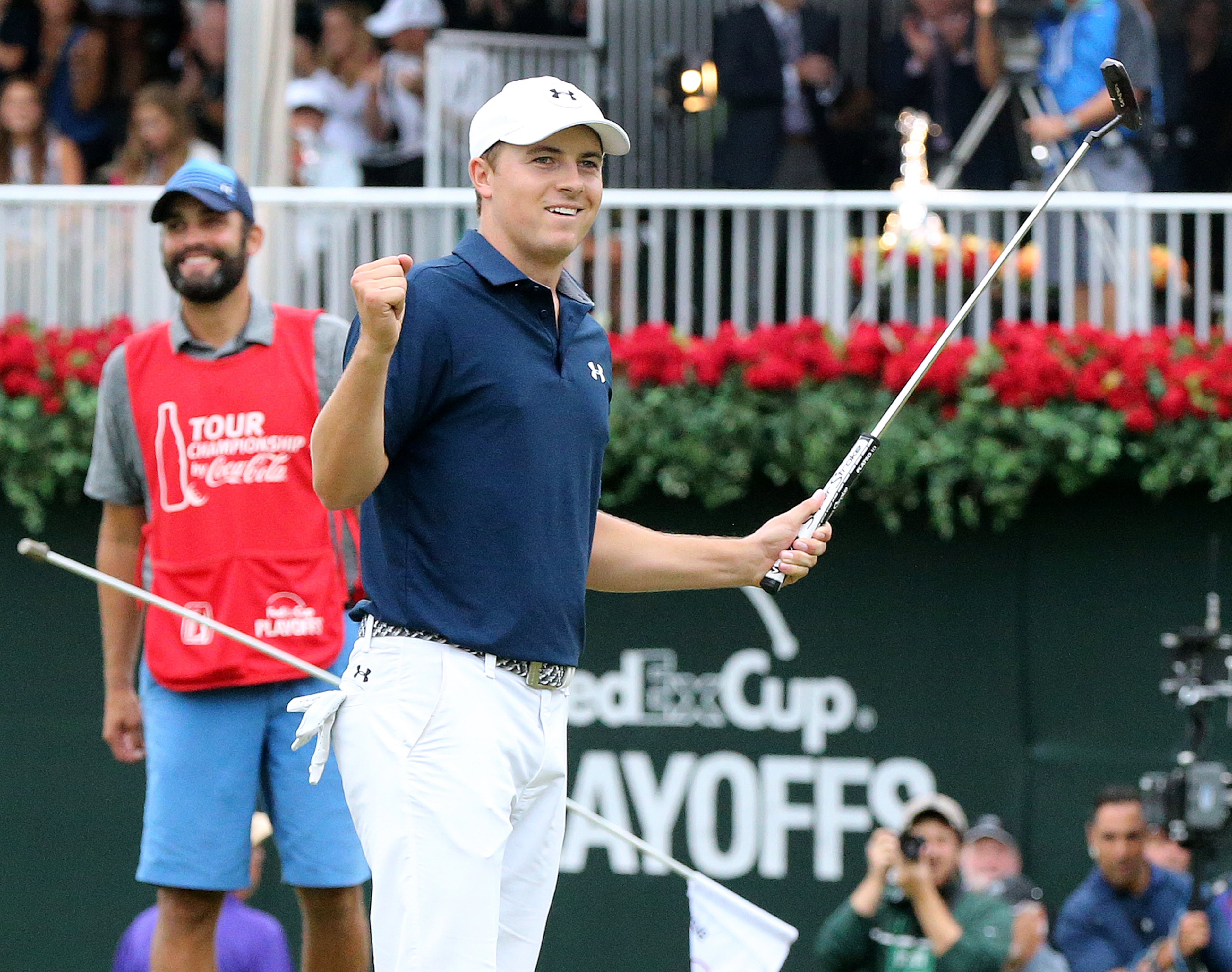 Jordan Spieth and his caddie Michael Greller react as he sinks his par putt on the 18th green to win the Tour Championship and the FedEx Cup at East Lake Golf Club on Sunday, Sept. 27, 2015, in Atlanta. Curtis Compton / ccompton@ajc.com