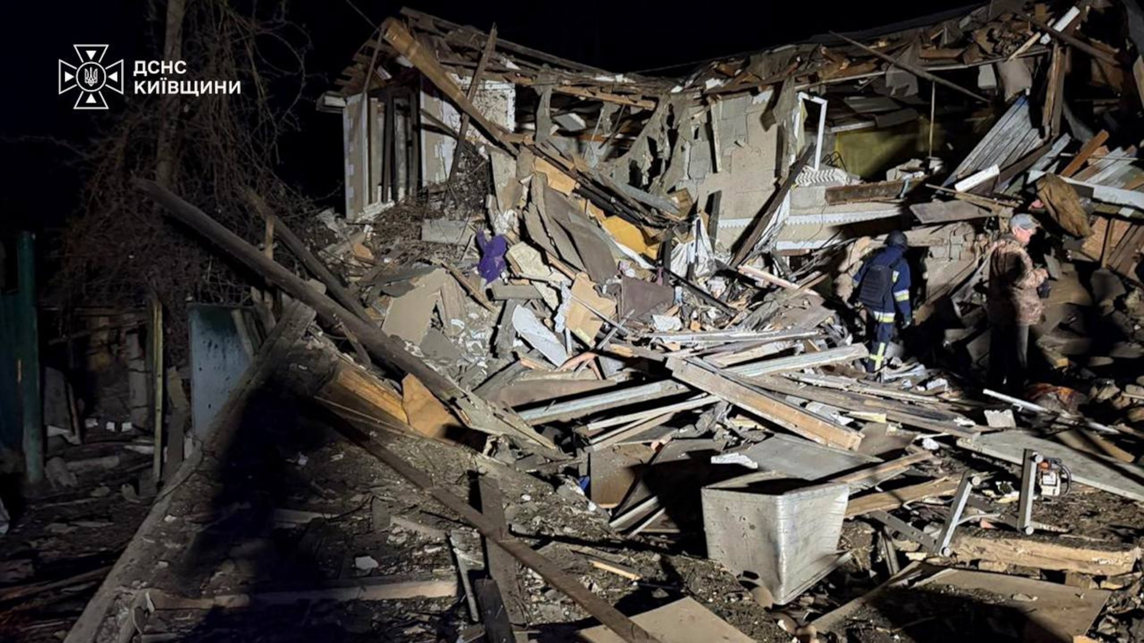 In this photo provided by the Ukrainian Emergency Services on Wednesday, Sept. 30, 2026, a rescuer walks on a site of a Russian drone strike on residential house in Kyiv region, Ukraine. (Ukrainian Emergency Service via AP)