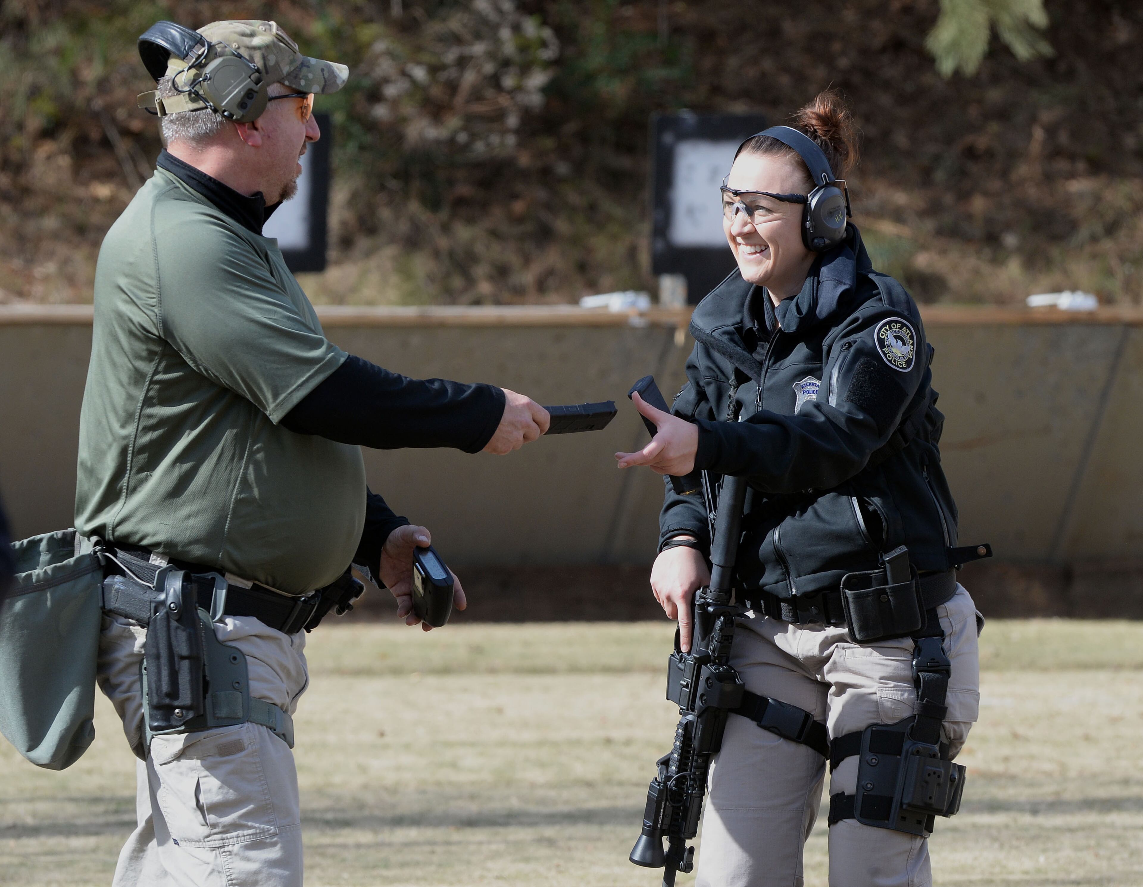 NOVEMBER 24, 2015 ATLANTA APD Officer Heather Vernon takes an empty clip from instructor Eugene Haragsim while leaving the range. KENT D. JOHNSON/ kdjohnson@ajc.com