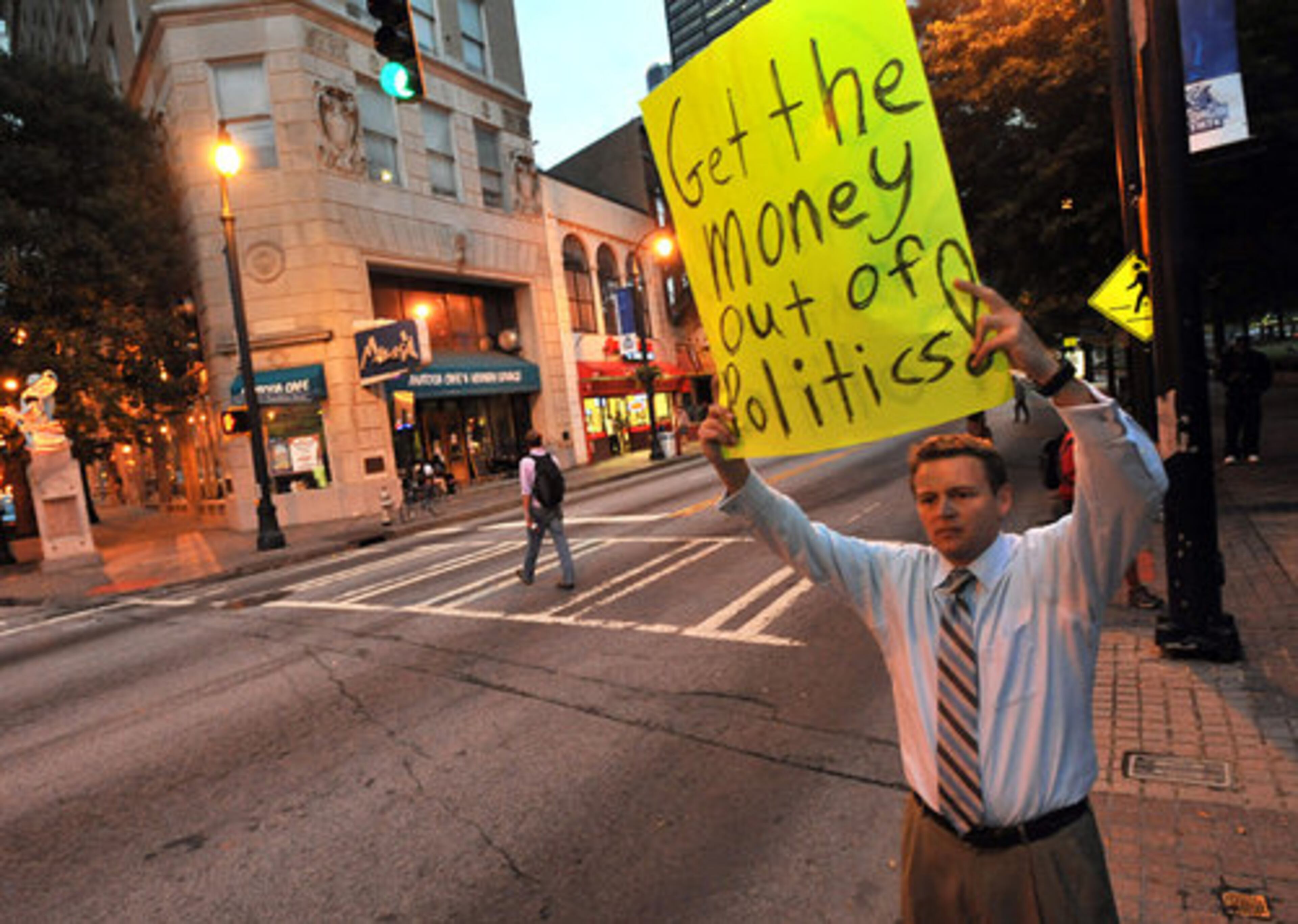 Jonathan Byers, who introduced himself as a programmer at Morgan Stanley, holds a picket to support Occupy Atlanta near Woodruff Park on Thursday evening,