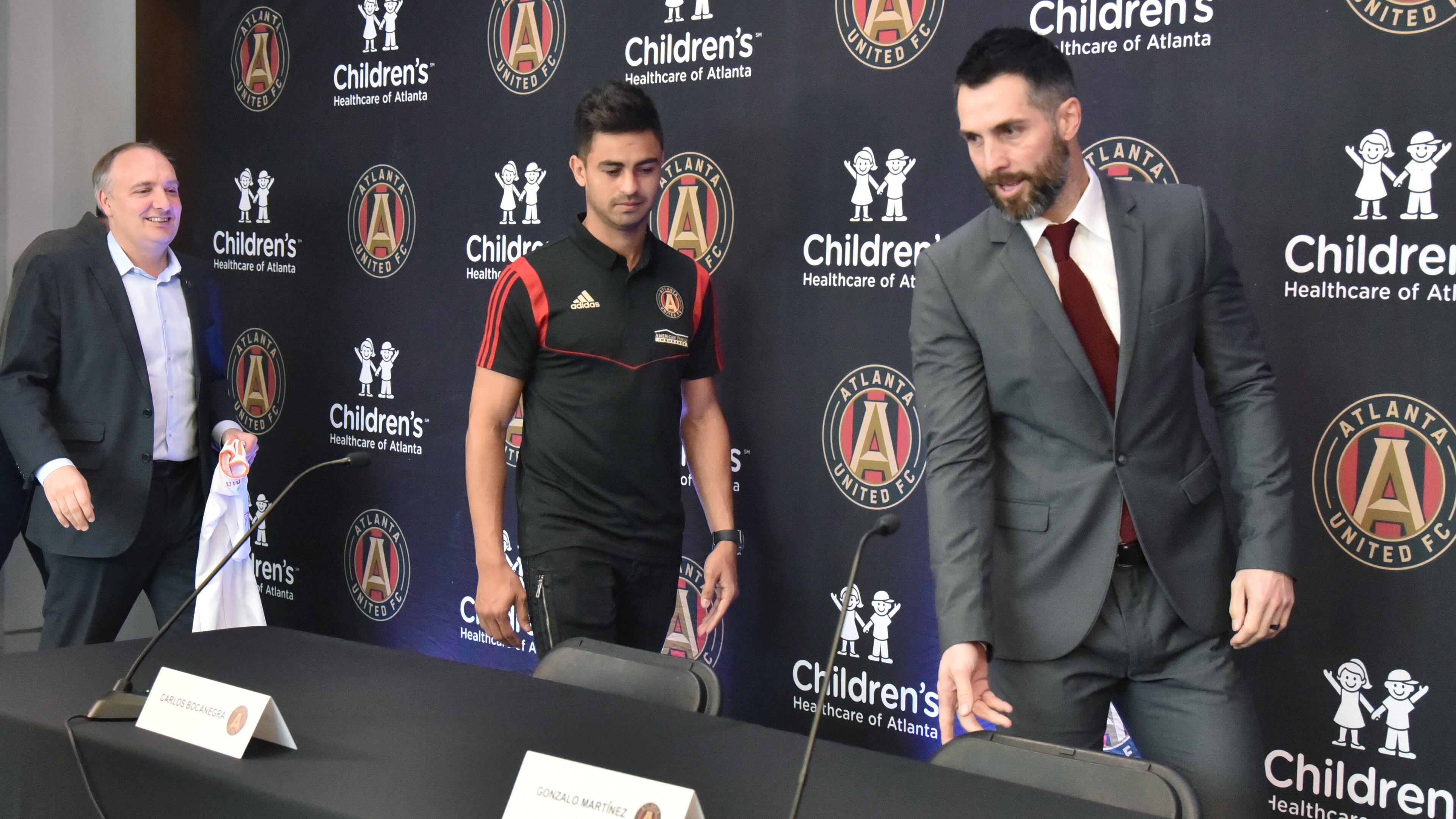 Atlanta United's Darren Eales (from left), Gonzalo "Pity" Martinez and Carlos Bocanegra find their place during the introductory press conference for Gonzalez Friday, Jan. 25, 2019, at the Children's Healthcare of Atlanta Training Ground in Marietta.
