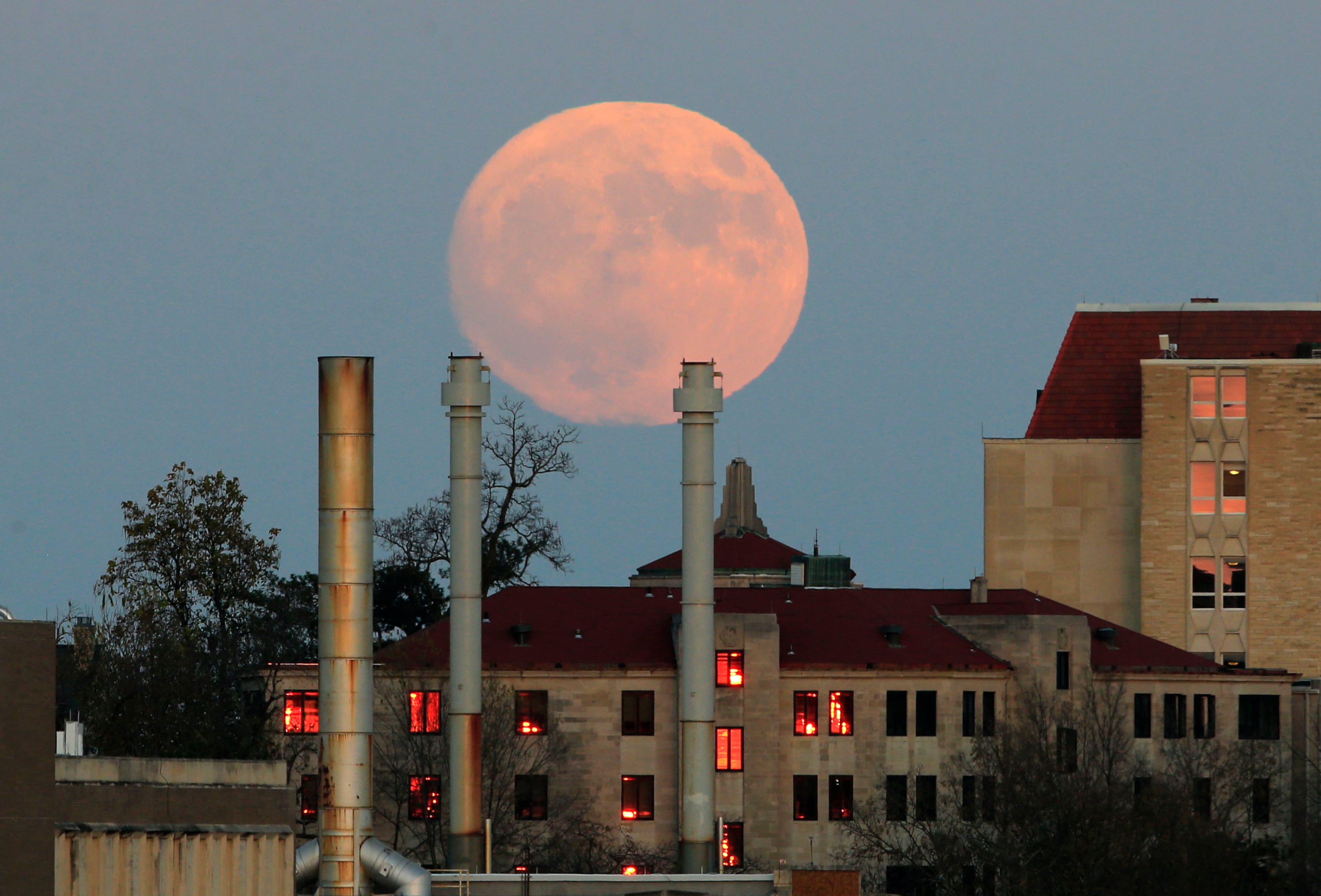 The moon rises beyond the University of Kansas campus in Lawrence, Kan., Sunday, Nov. 13, 2016. The morning's supermoon will be the closest a full moon has been to Earth since Jan. 26, 1948. (AP Photo/Orlin Wagner)