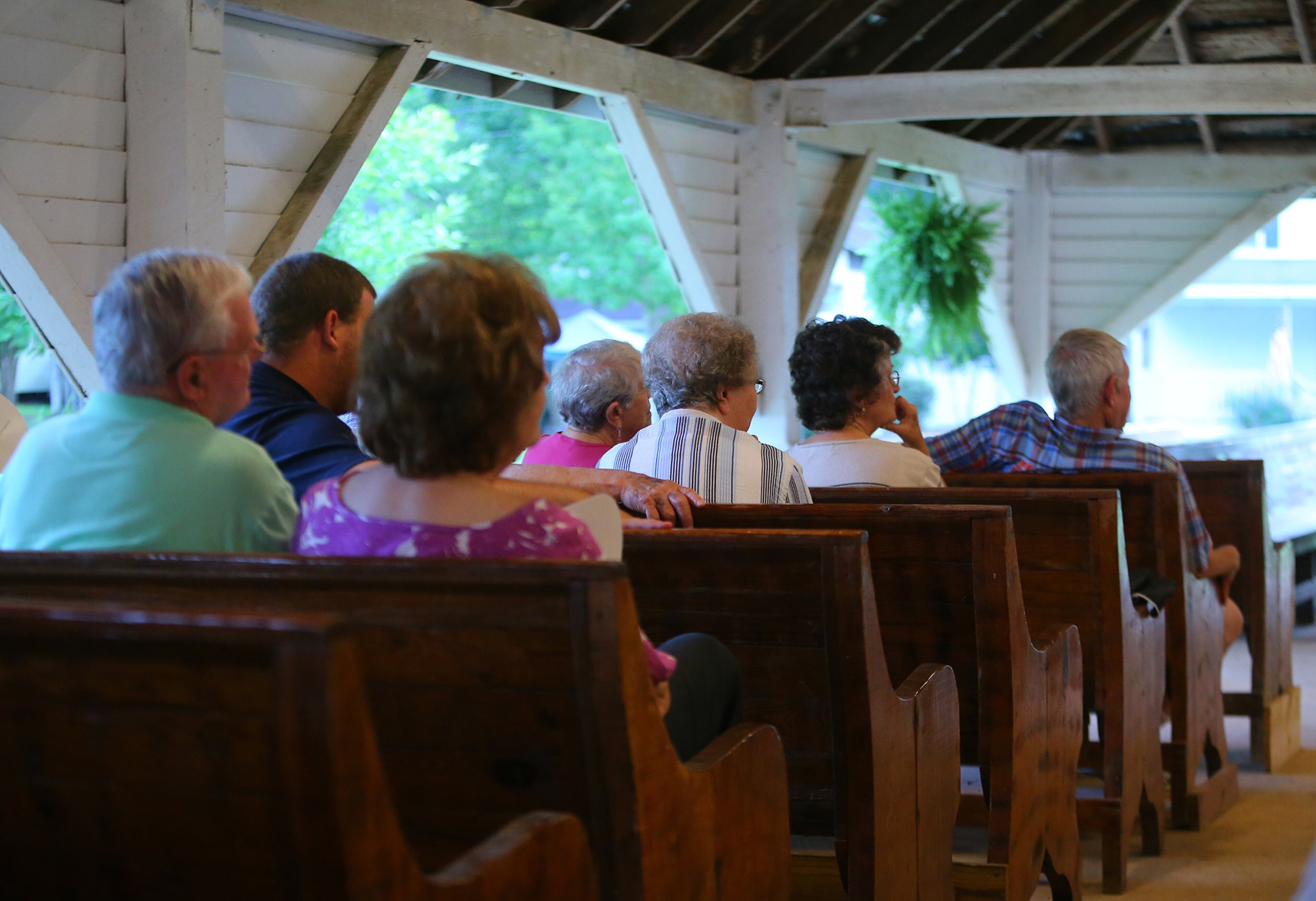 Campers and visitors listen to the sermon during the evening worship service under the tabernacle at the Smyrna Presbyterian Church camp meeting on Tuesday, June 24, 2014, in Conyers.