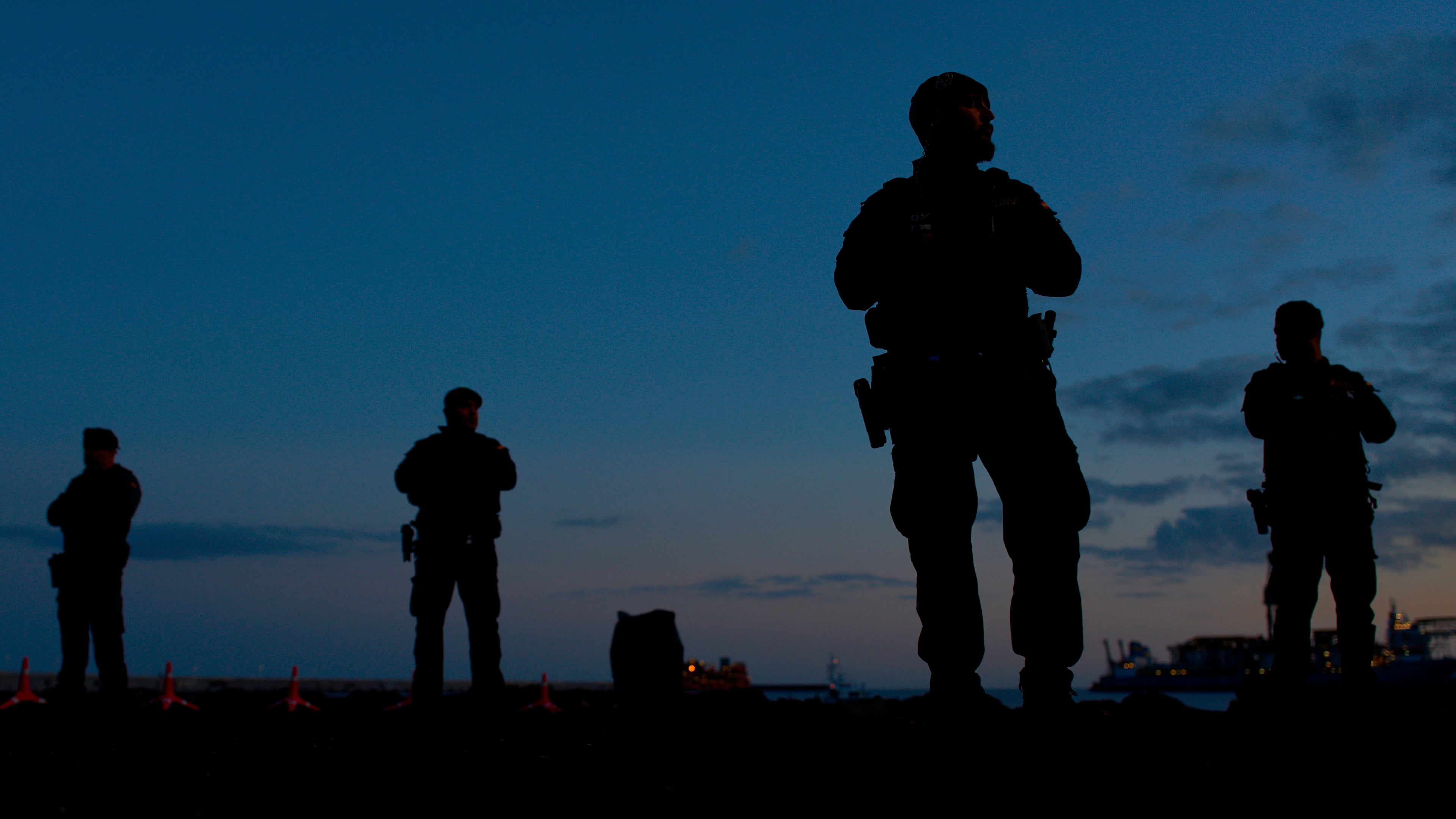 Spanish Civil Guard officers stand guard in the area where passengers from the MV Hondius cruise ship are expected to arrive at the port of Granadilla in Tenerife, Canary Islands, Spain, Saturday, May 9, 2026. (AP Photo/Manu Fernandez)