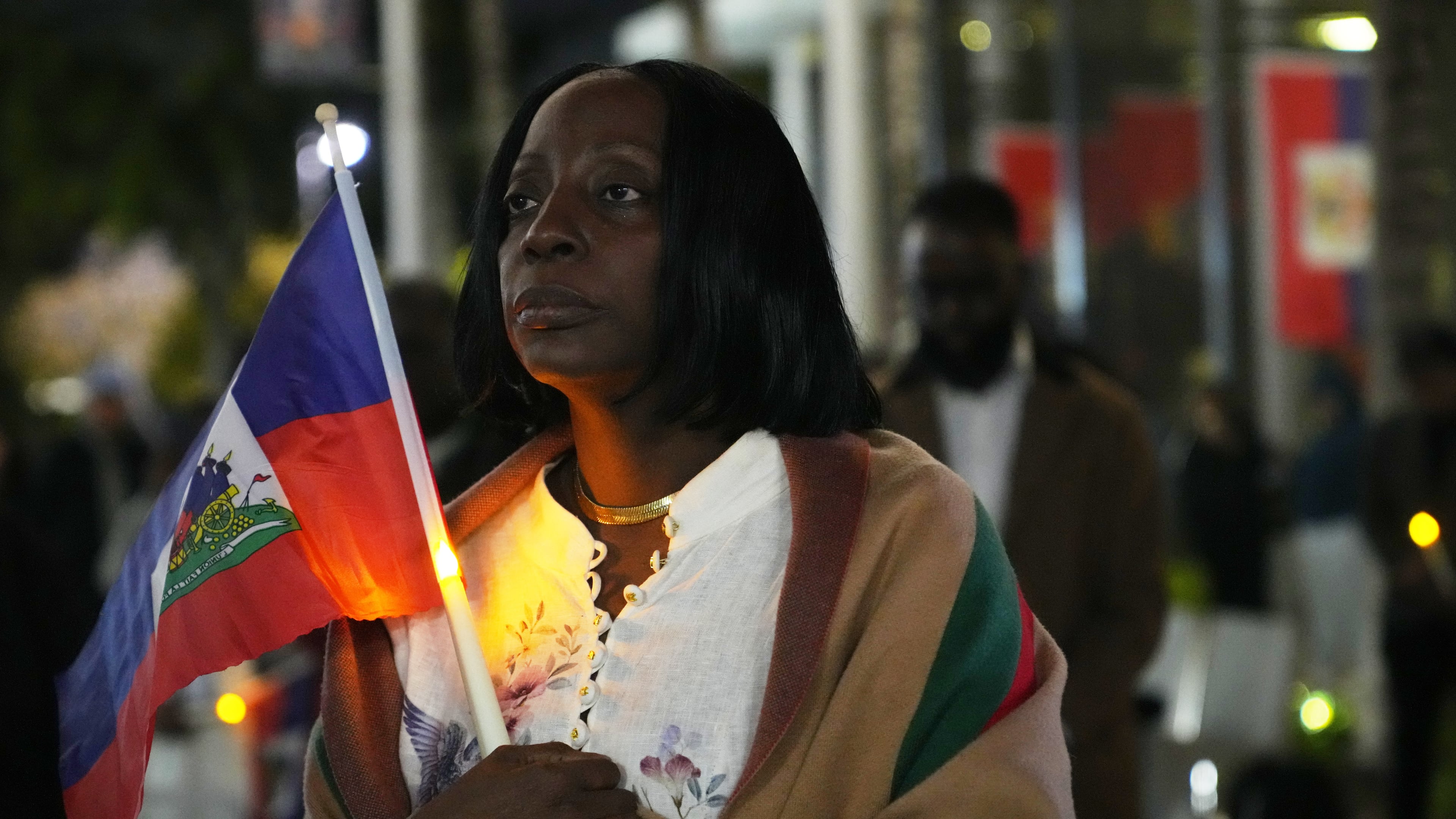 FILE - Linda Joseph holds a candle during a vigil at the Little Haiti Cultural Complex after a federal judge blocked the Trump administration from ending temporary immigration status, or TPS, for Haitians, Tuesday, Feb. 3, 2026, in North Miami. (AP Photo/Lynne Sladky, File)