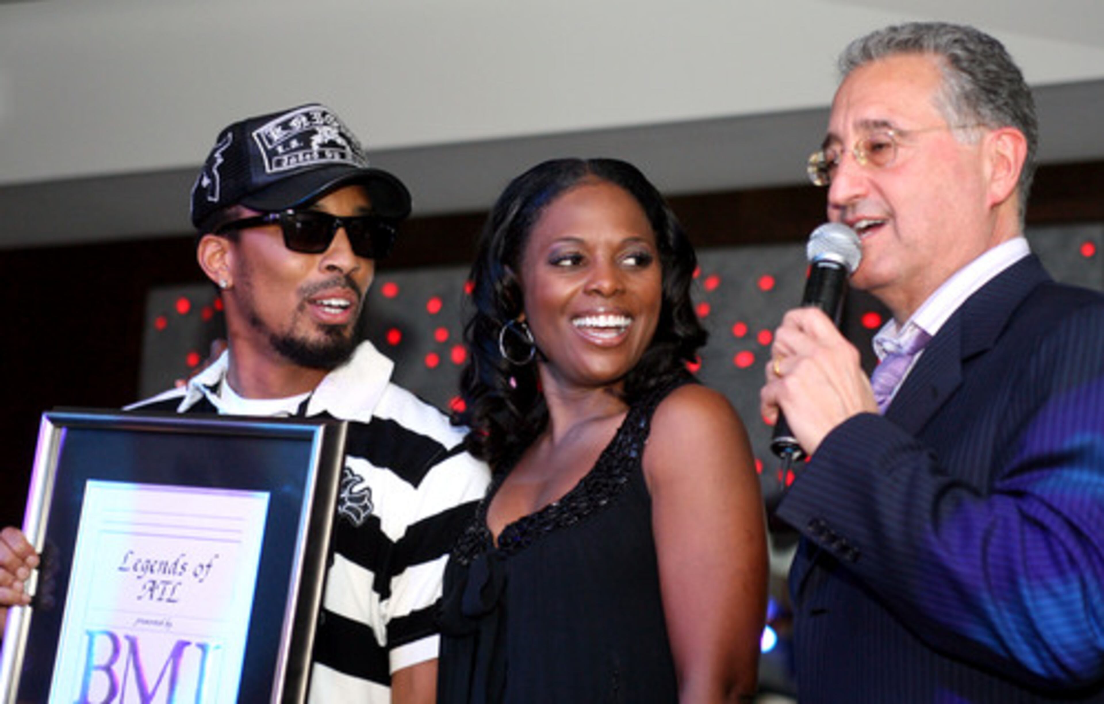 BMI BIGWIGS CATHERINE BREWTON (center) and Del Bryant (right) present producer/songwriter Dallas Austin with the "Legends of Atlanta Award" ...