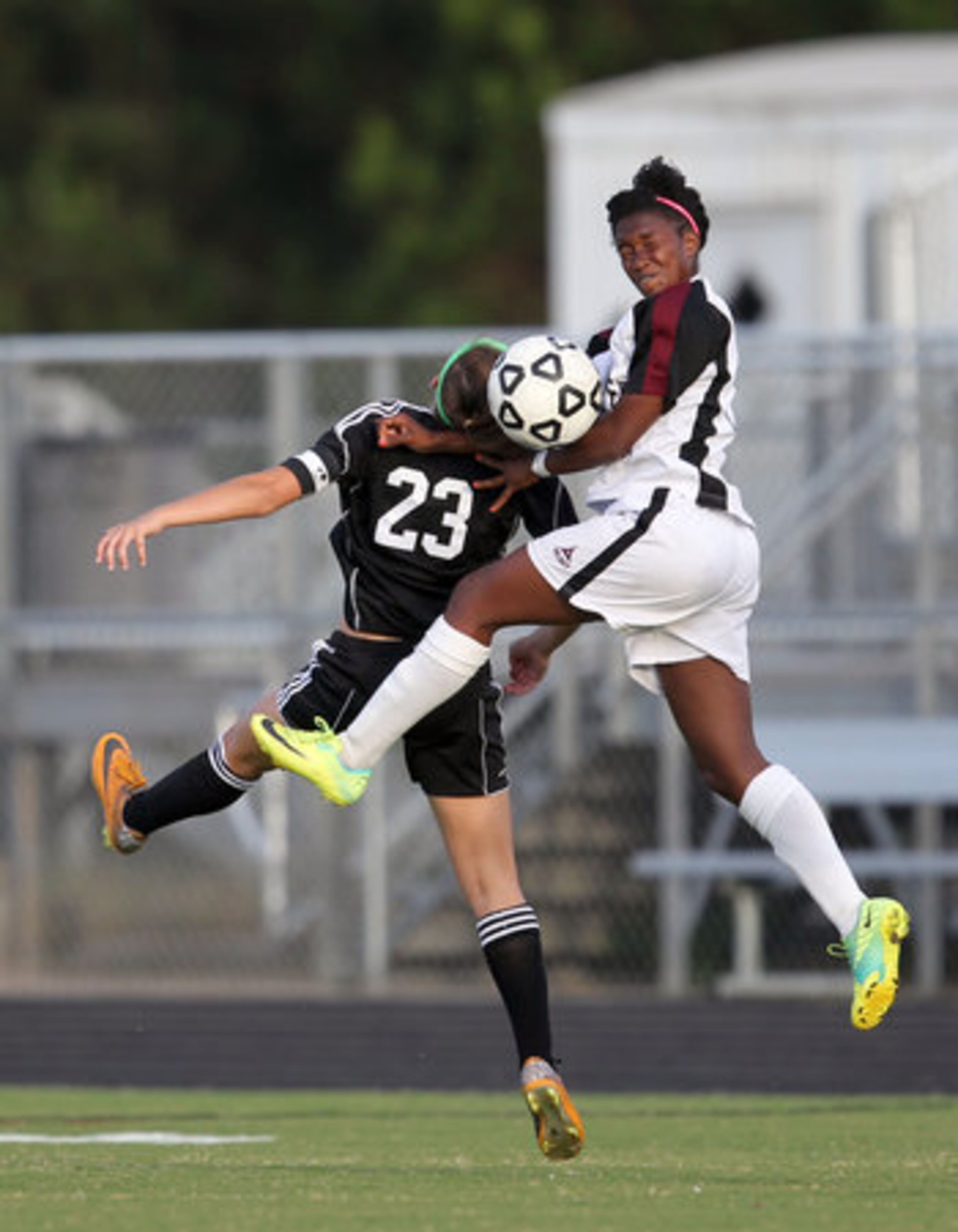 McIntosh's Gabby Seiler (23) and Whitewater's Ojwanna Wilson, right, go for a header in the first half of their Class AAAA girls soccer state championship game at Whitewater High School Saturday afternoon in Fayetteville, Ga., May 19, 2012.