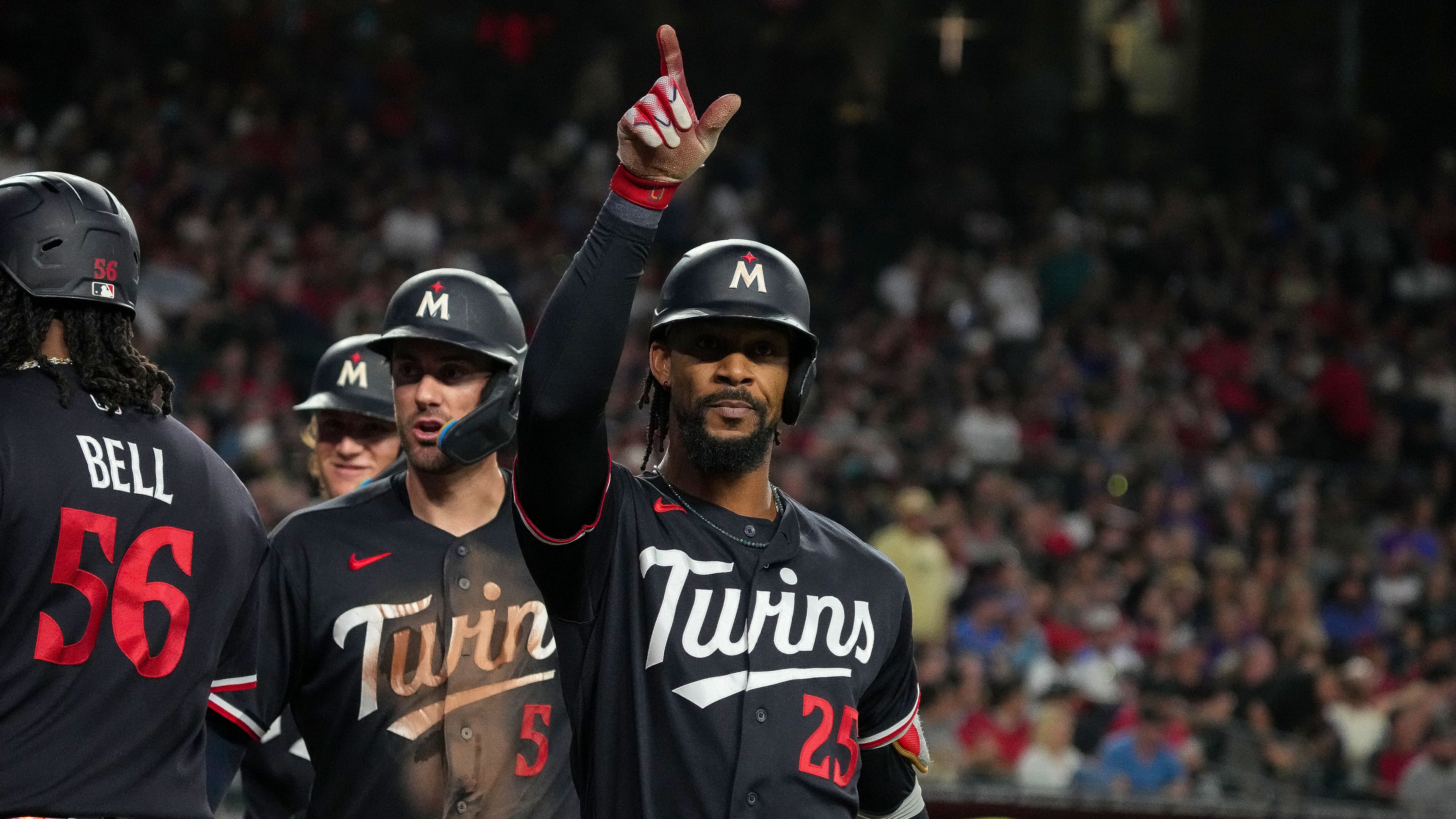 Minnesota Twins' Byron Buxton (25) celebrates after hitting a grand slam with teammates Josh Bell (56) and Ryan Kreidler (5) in the fifth inning of a baseball game against Arizona Diamondbacks Saturday, June 20, 2026, in Phoenix. (AP Photo/Darryl Webb)